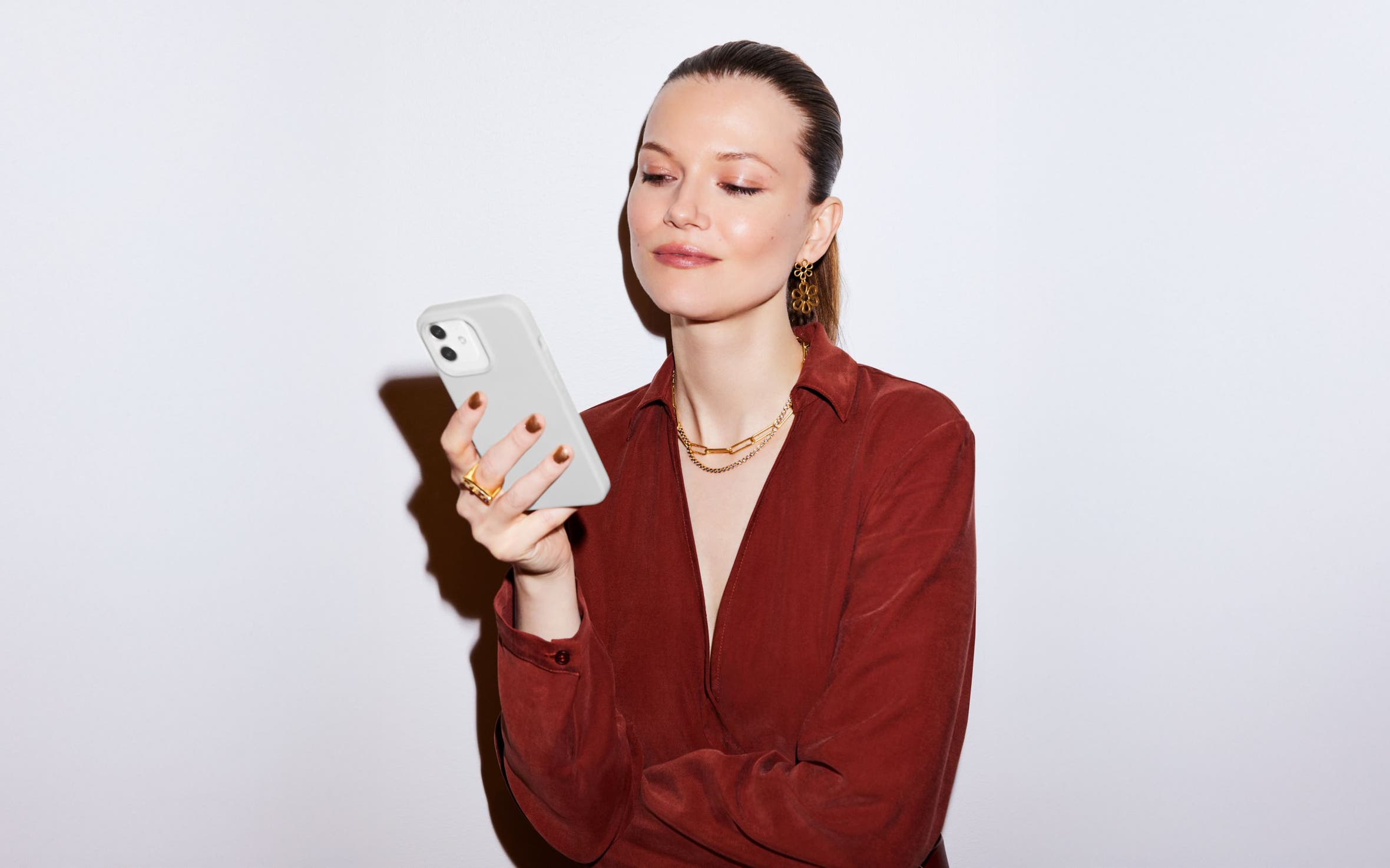 A woman looking at a cell phone.