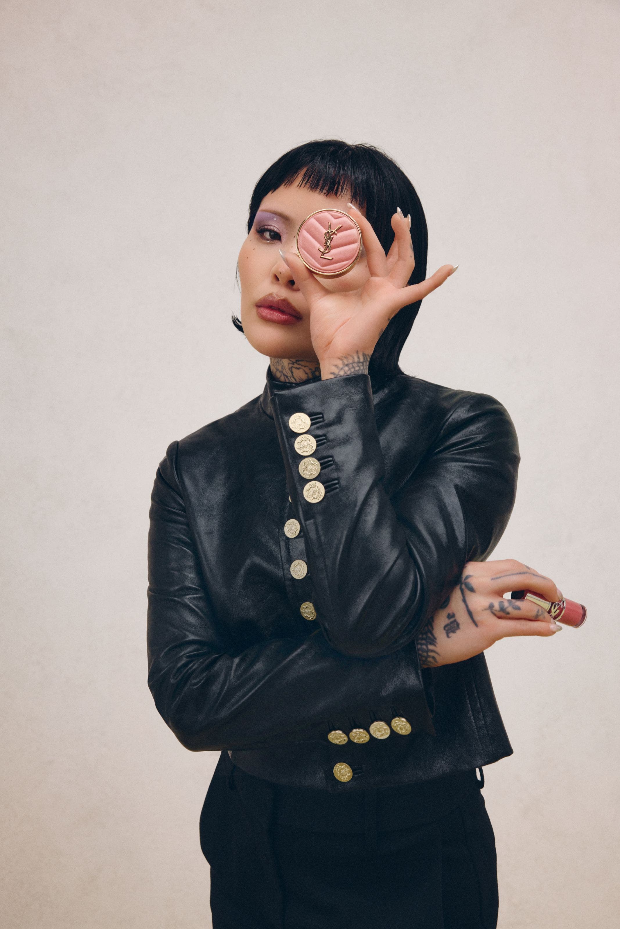 A women holding up blush makeup