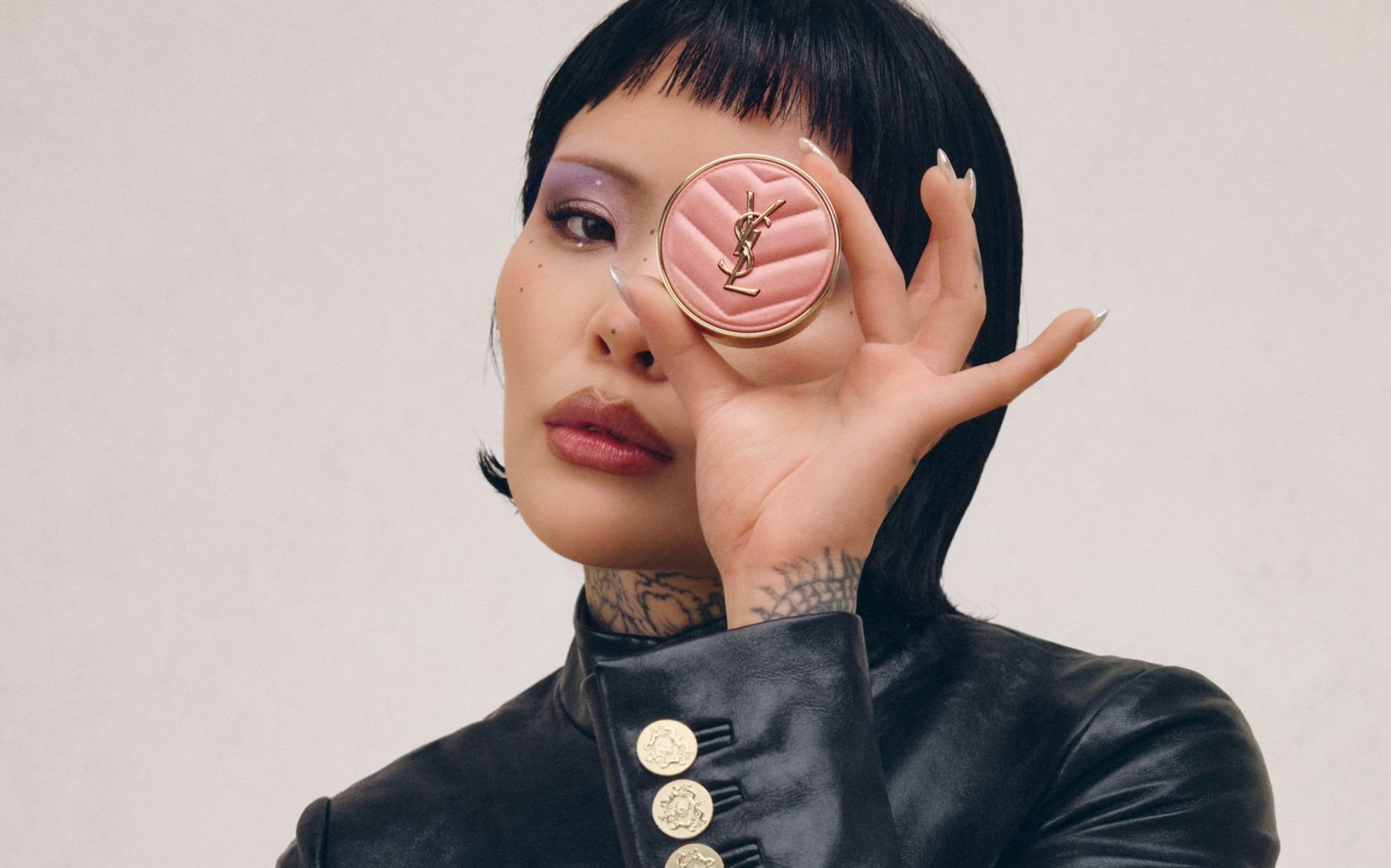 A women holding up blush makeup