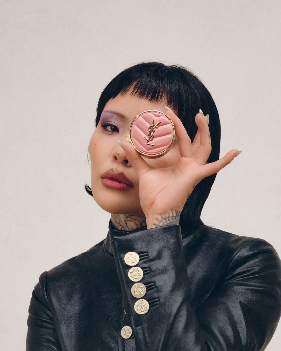 A women holding up blush makeup