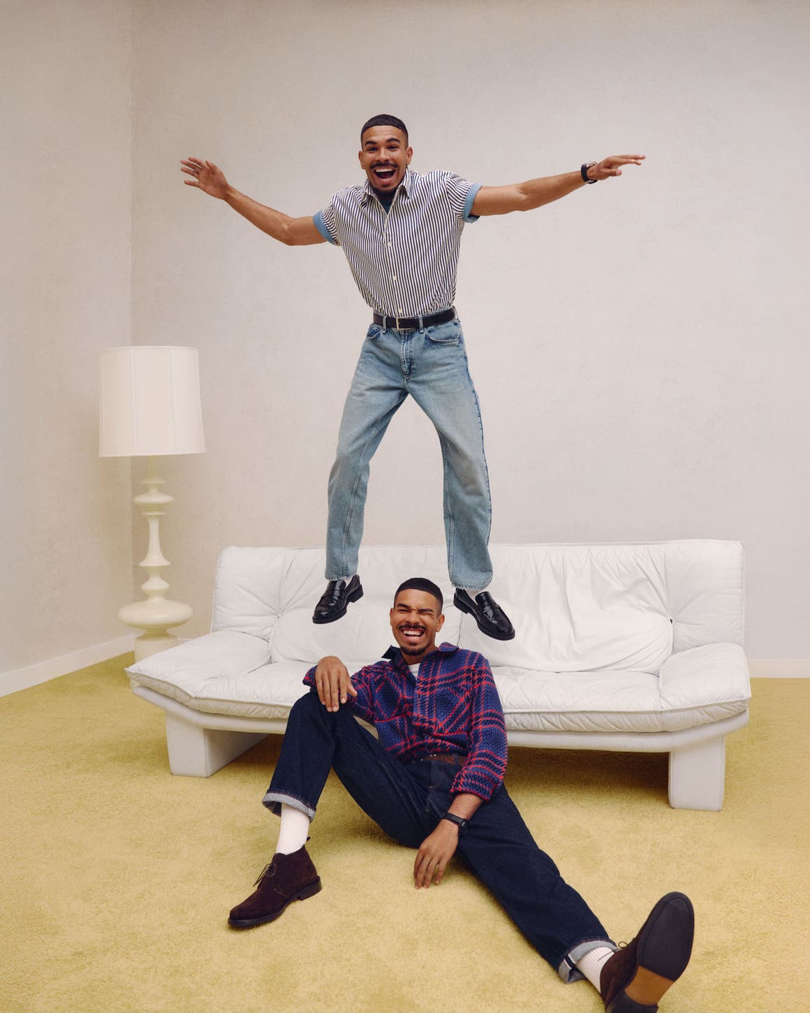 Two guys in anniversary jeans and shirts.