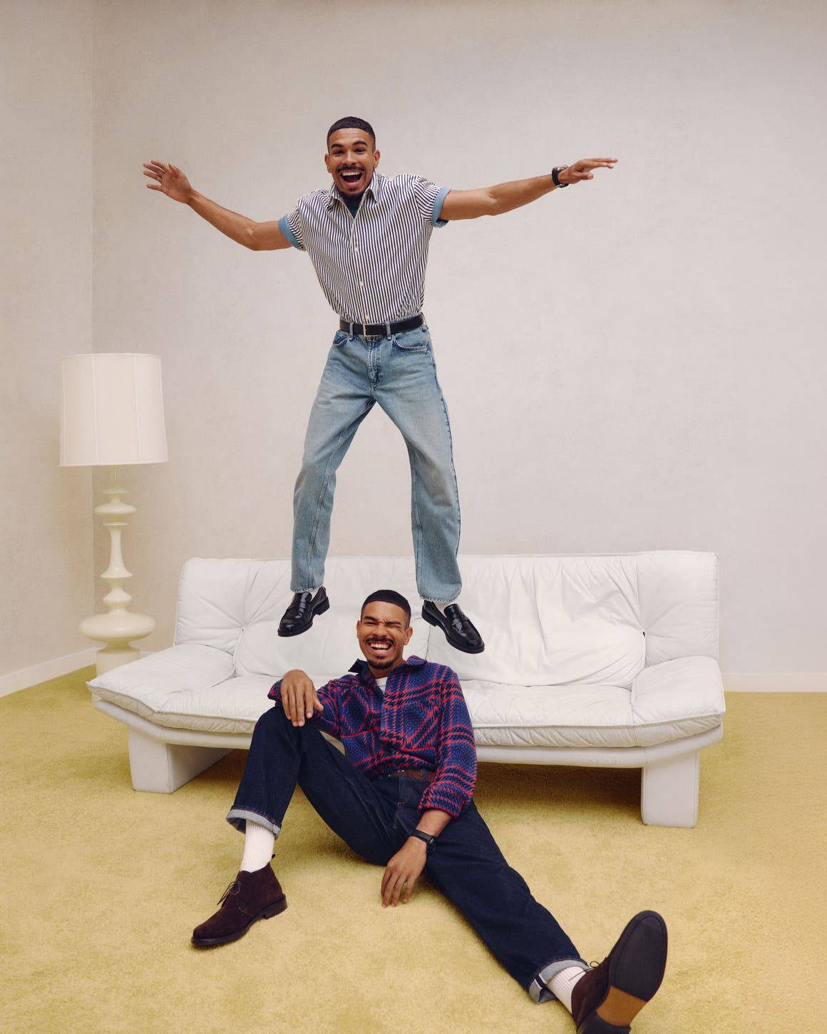 Two men wearing Anniversary Sale shirts and jeans.