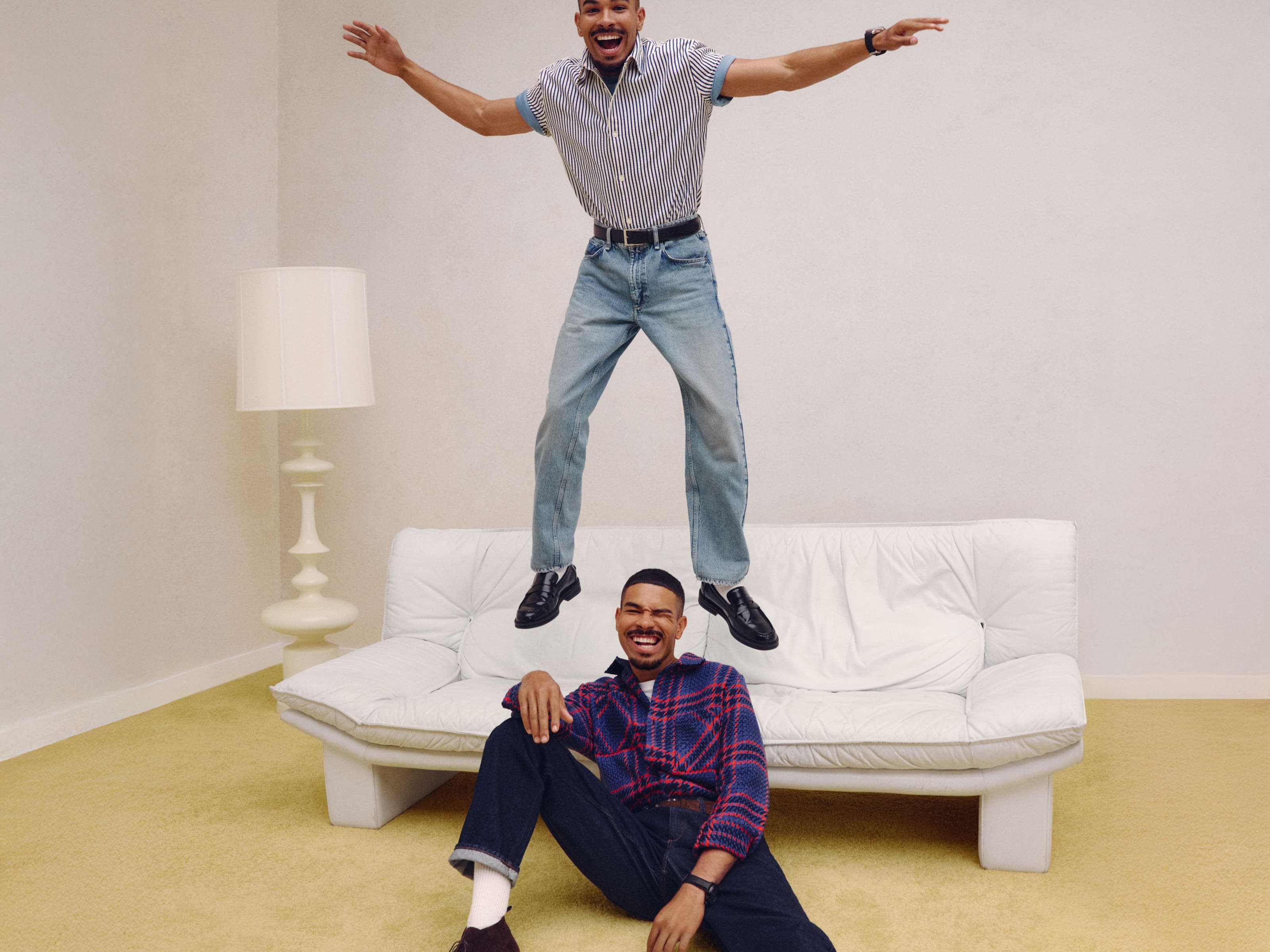 Two guys in anniversary jeans and shirts.