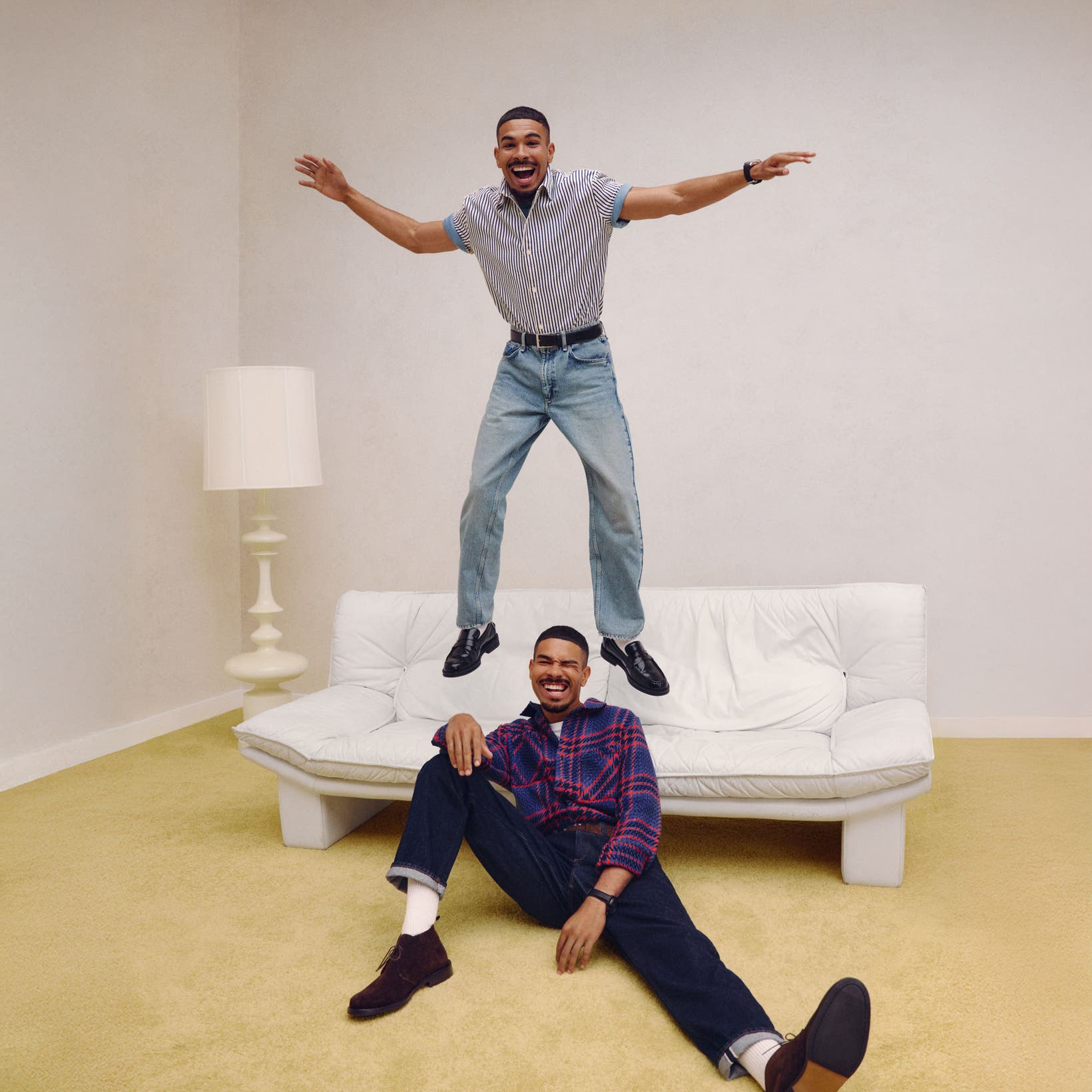 Two guys in anniversary jeans and shirts.