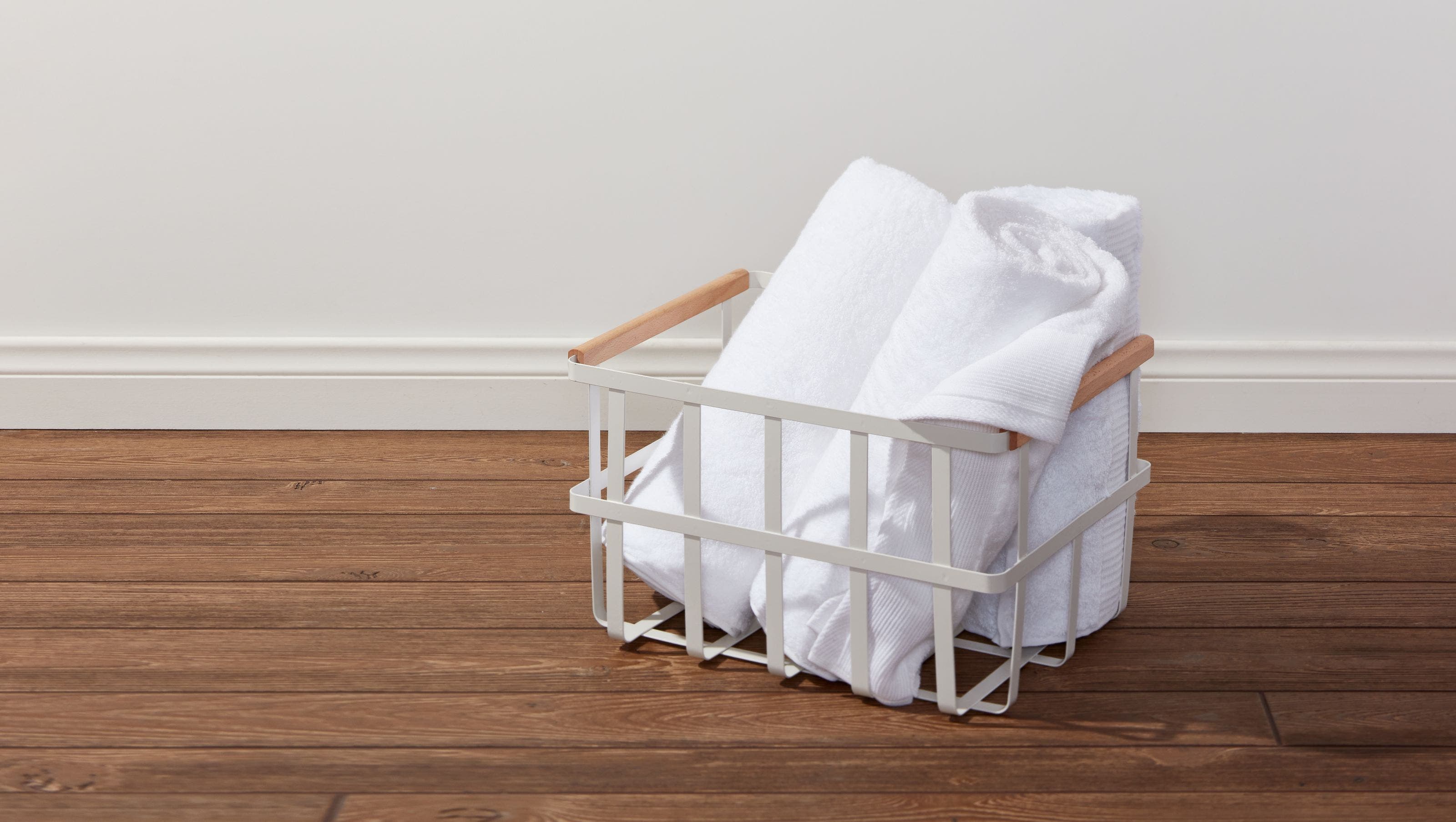 Rolled towels in a metal basket.