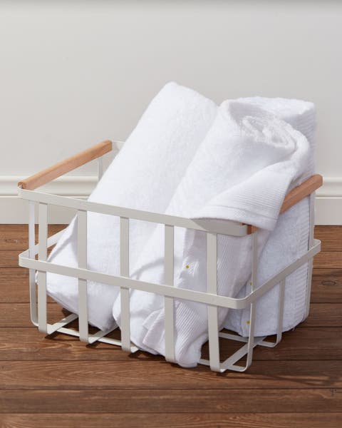 Rolled towels in a metal basket.