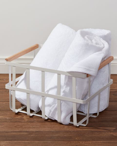 Rolled towels in a metal basket.