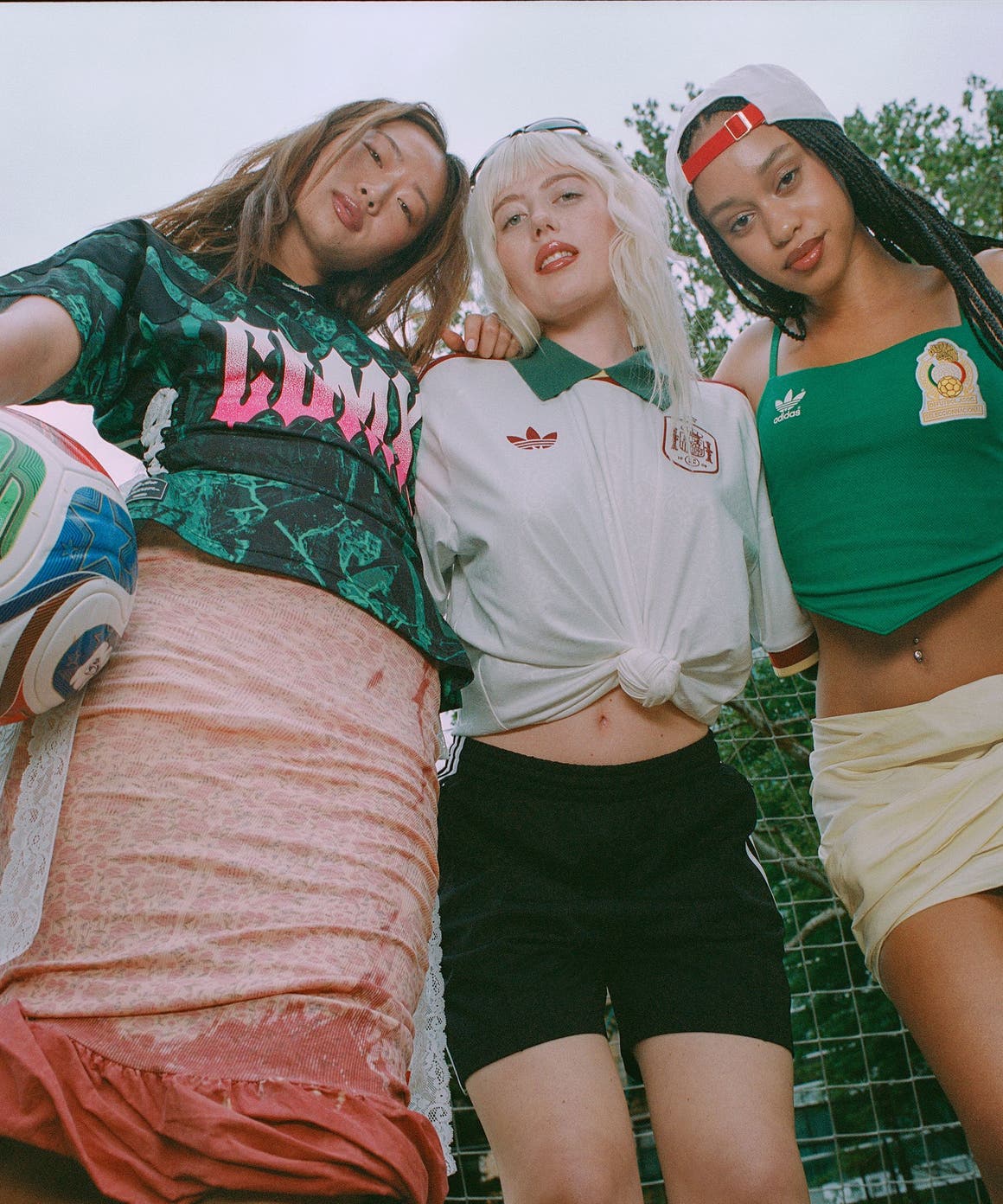 Three women in clothing and gear from the adidas and FIFA World Cup 2026 partnership.