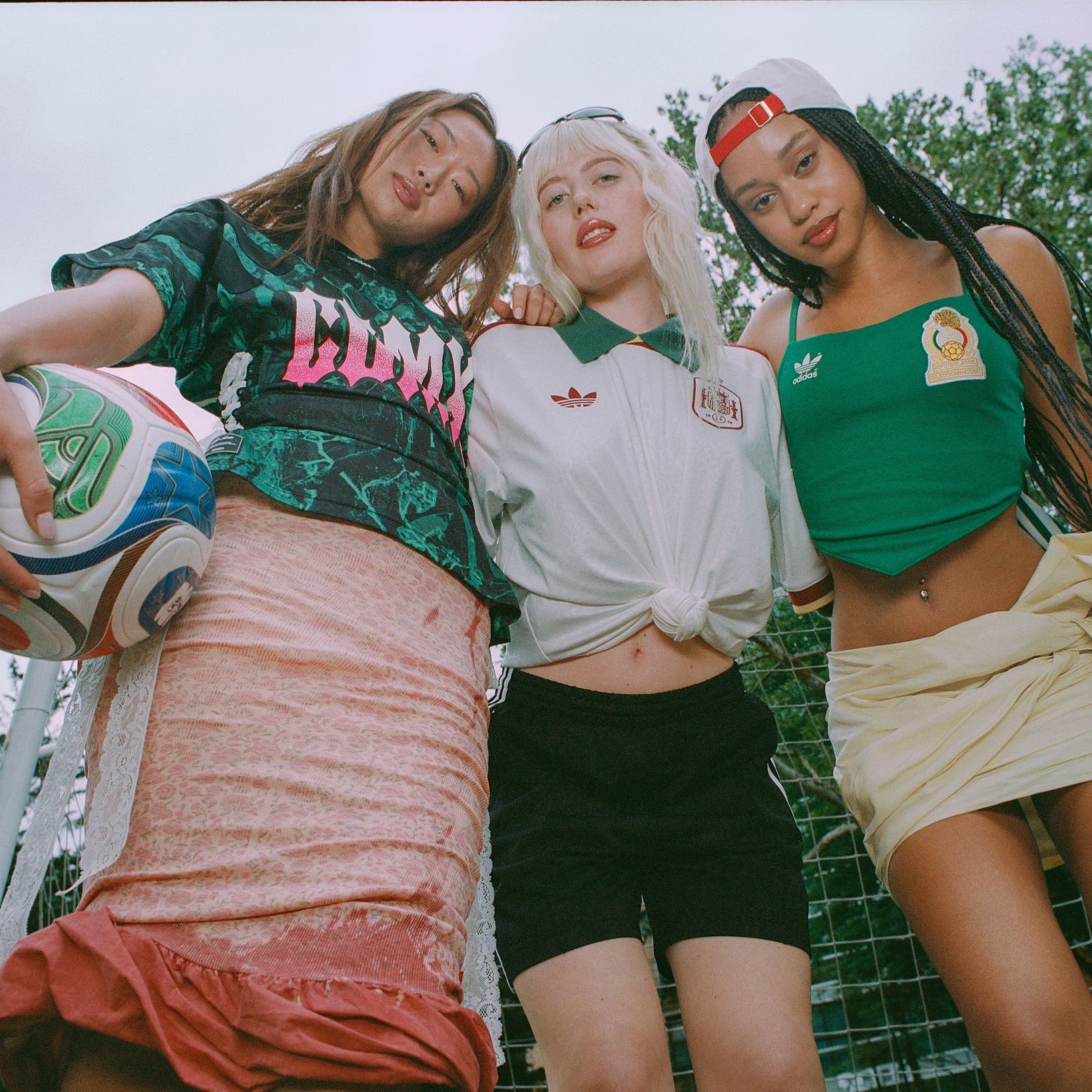 Three women in clothing and gear from the adidas and FIFA World Cup 2026 partnership.