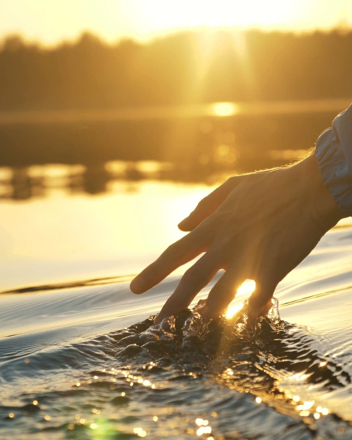 Hand brushing through water.