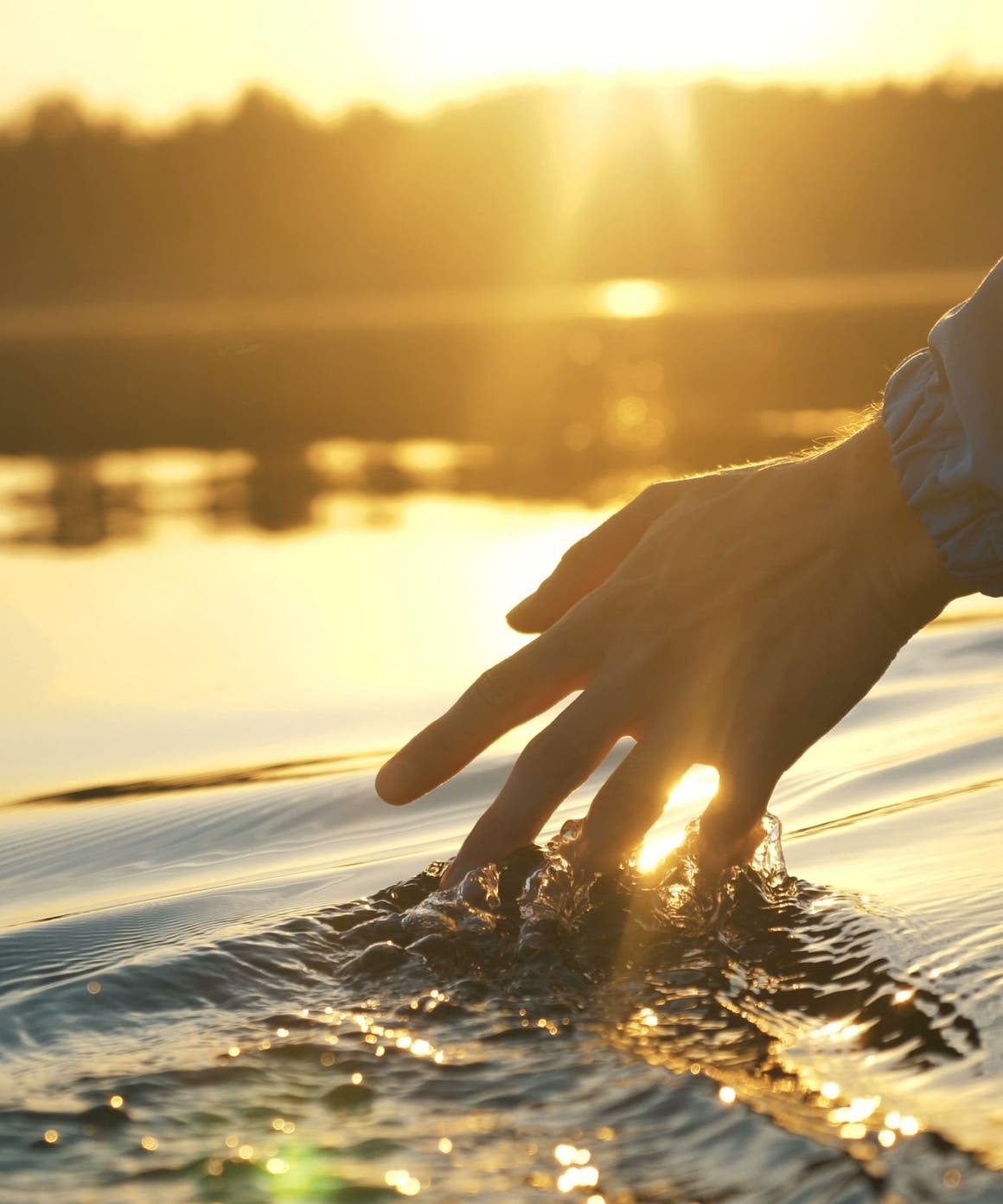 Hand brushing through water.