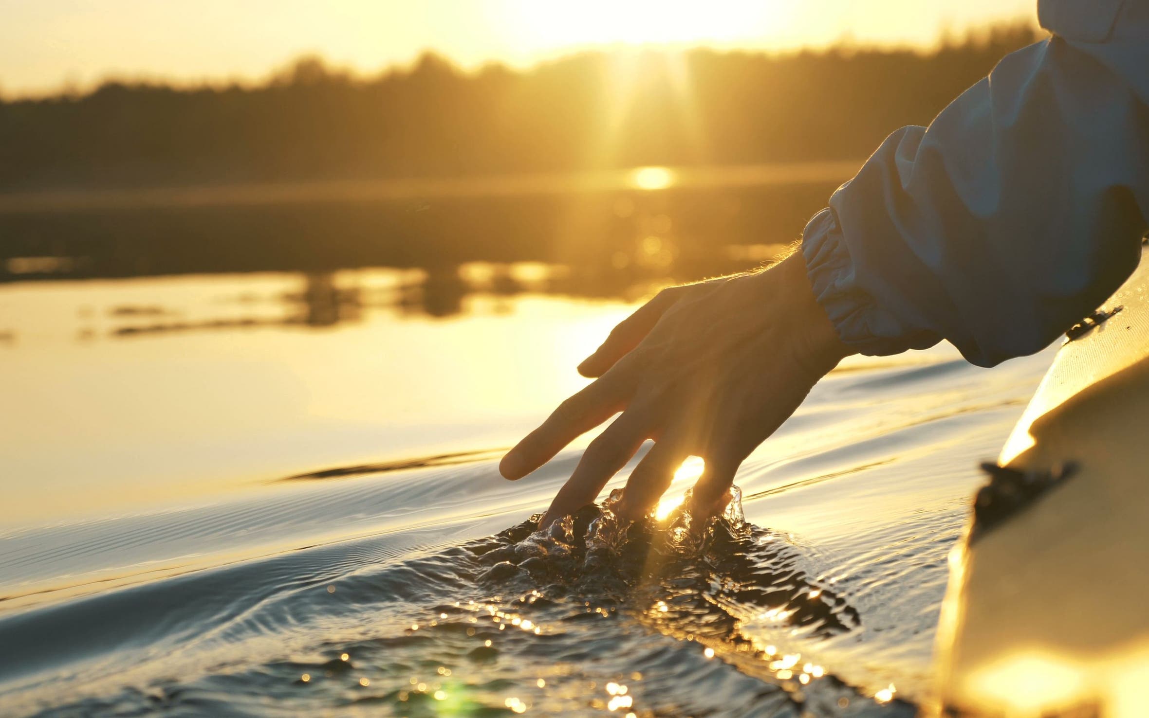 Hand brushing through water.