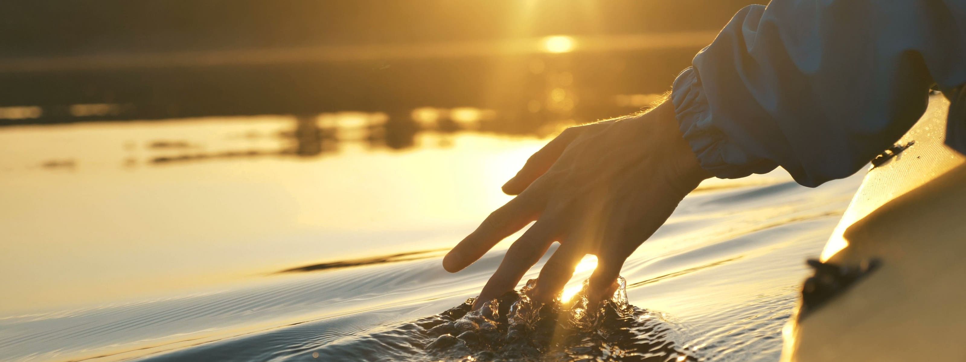 Hand brushing through water.