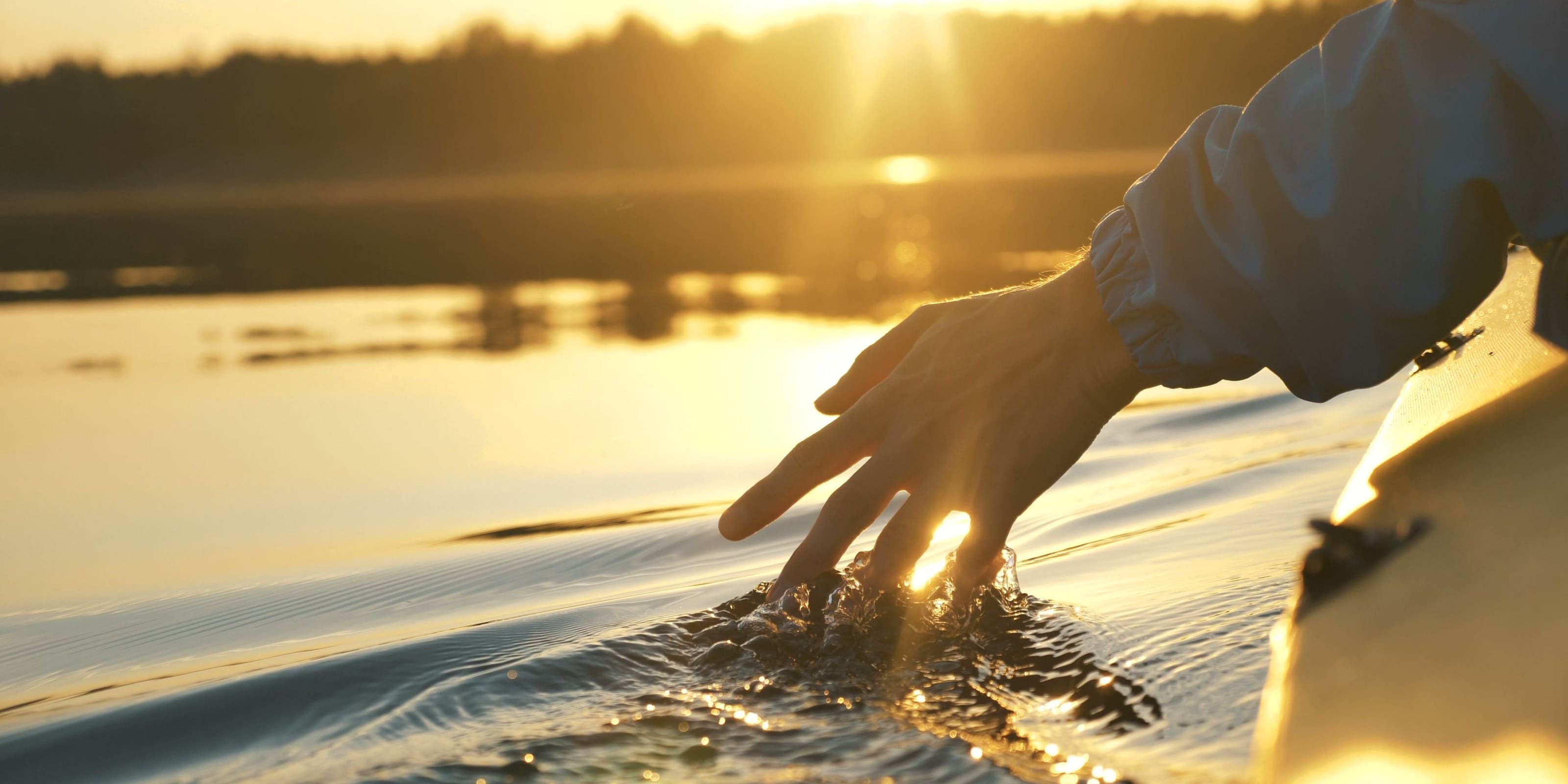 Hand brushing through water.
