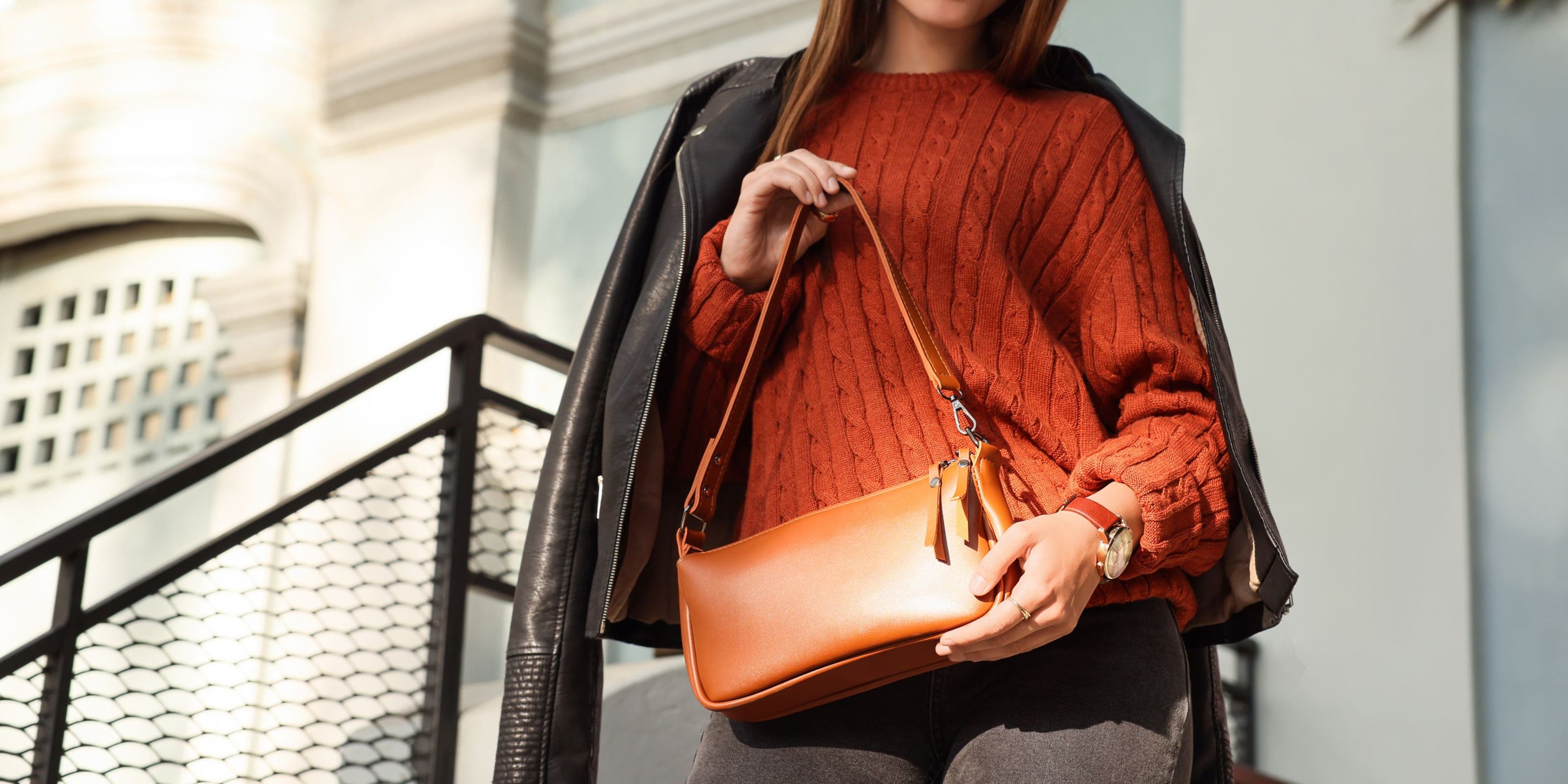 A woman holding a shoulder bag.