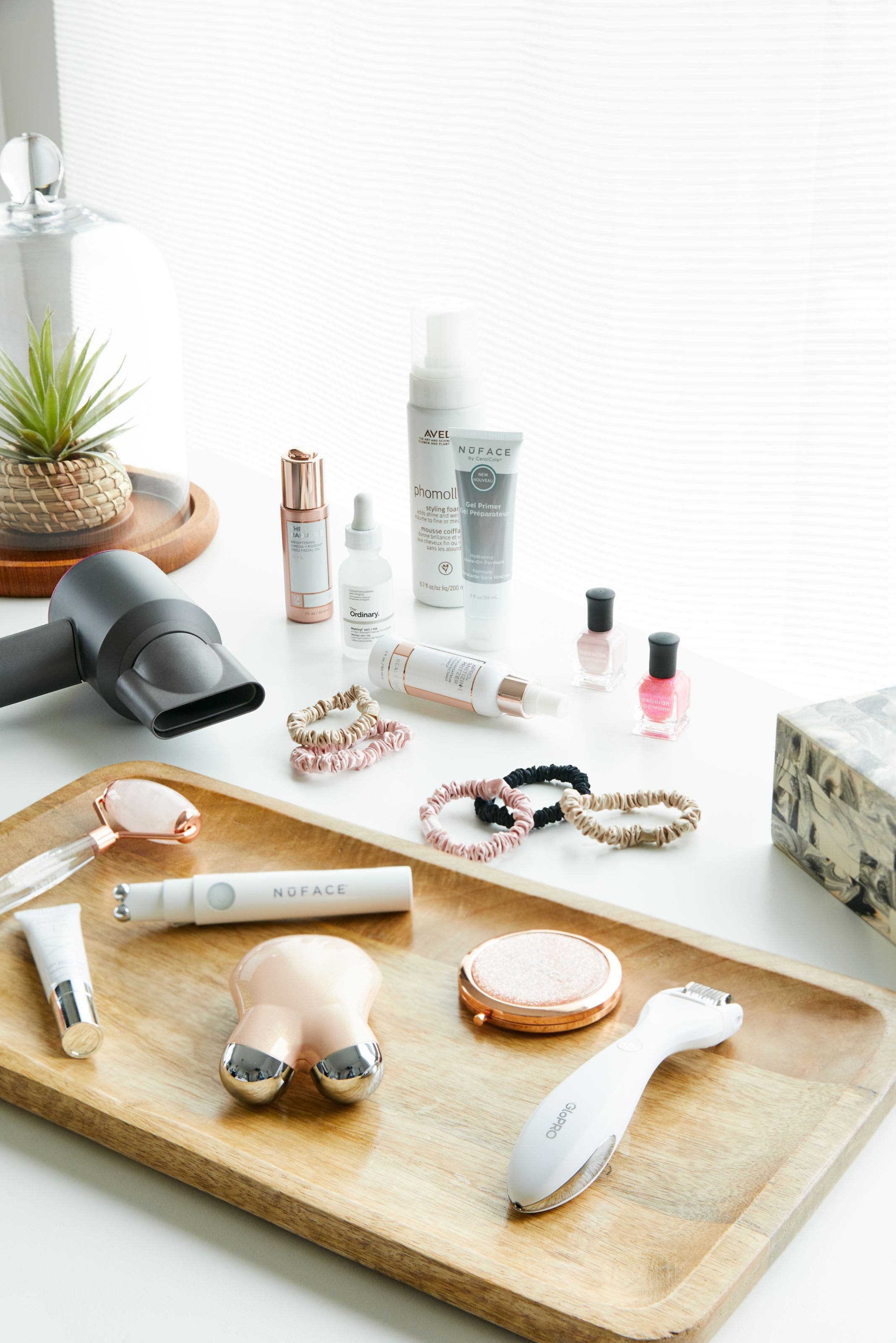 An array of beauty products and tools on a counter.