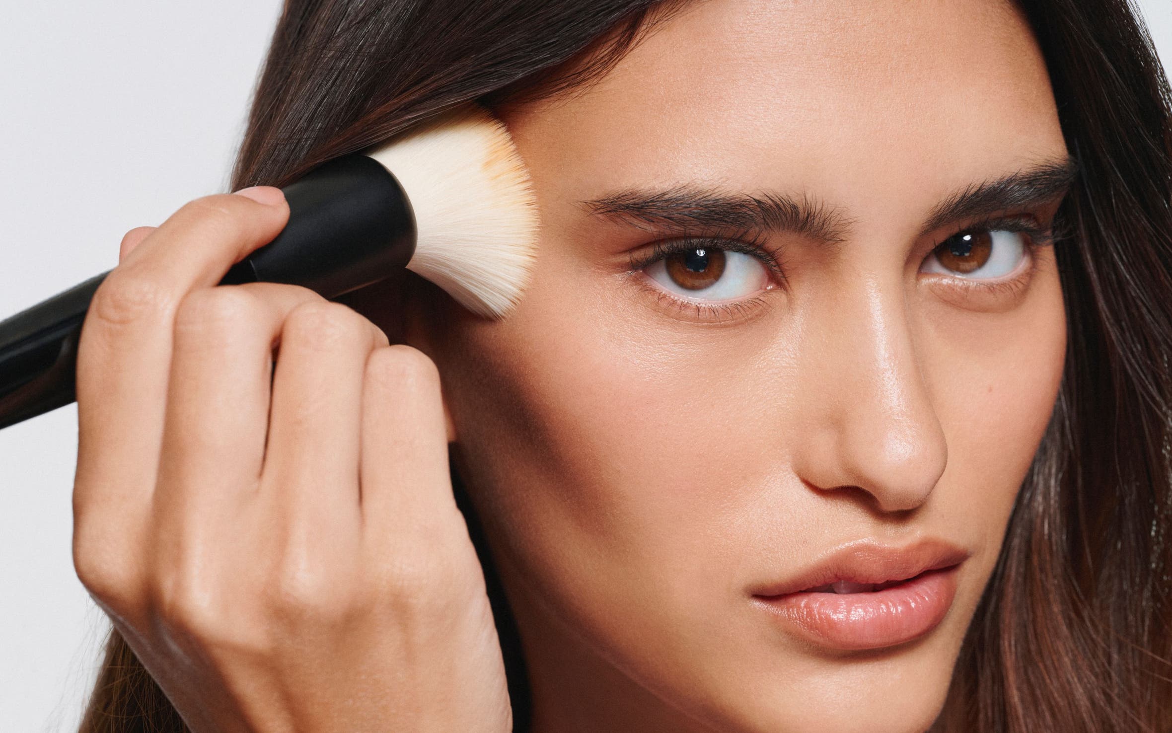 Woman applying makeup. 