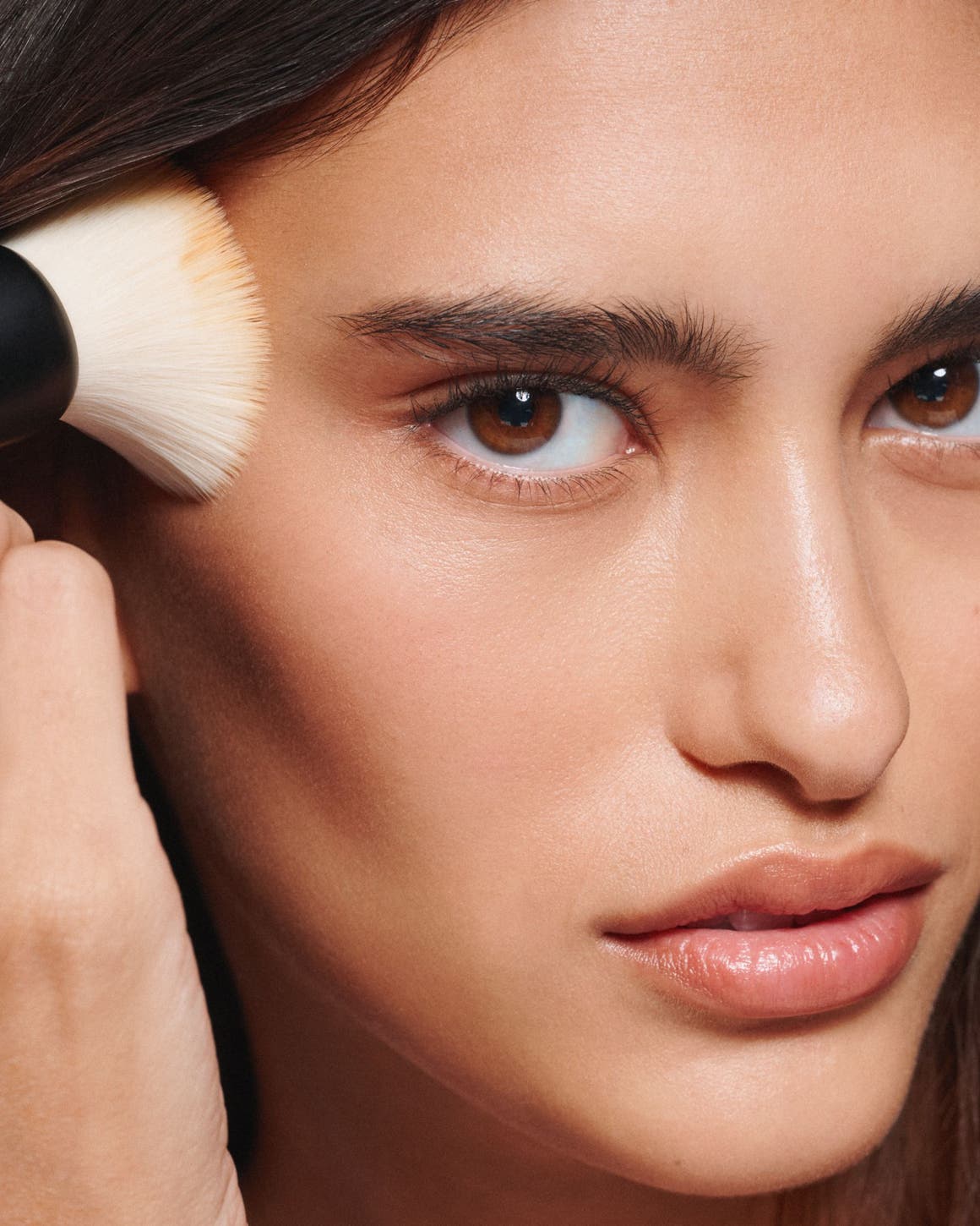 A woman applying makeup.