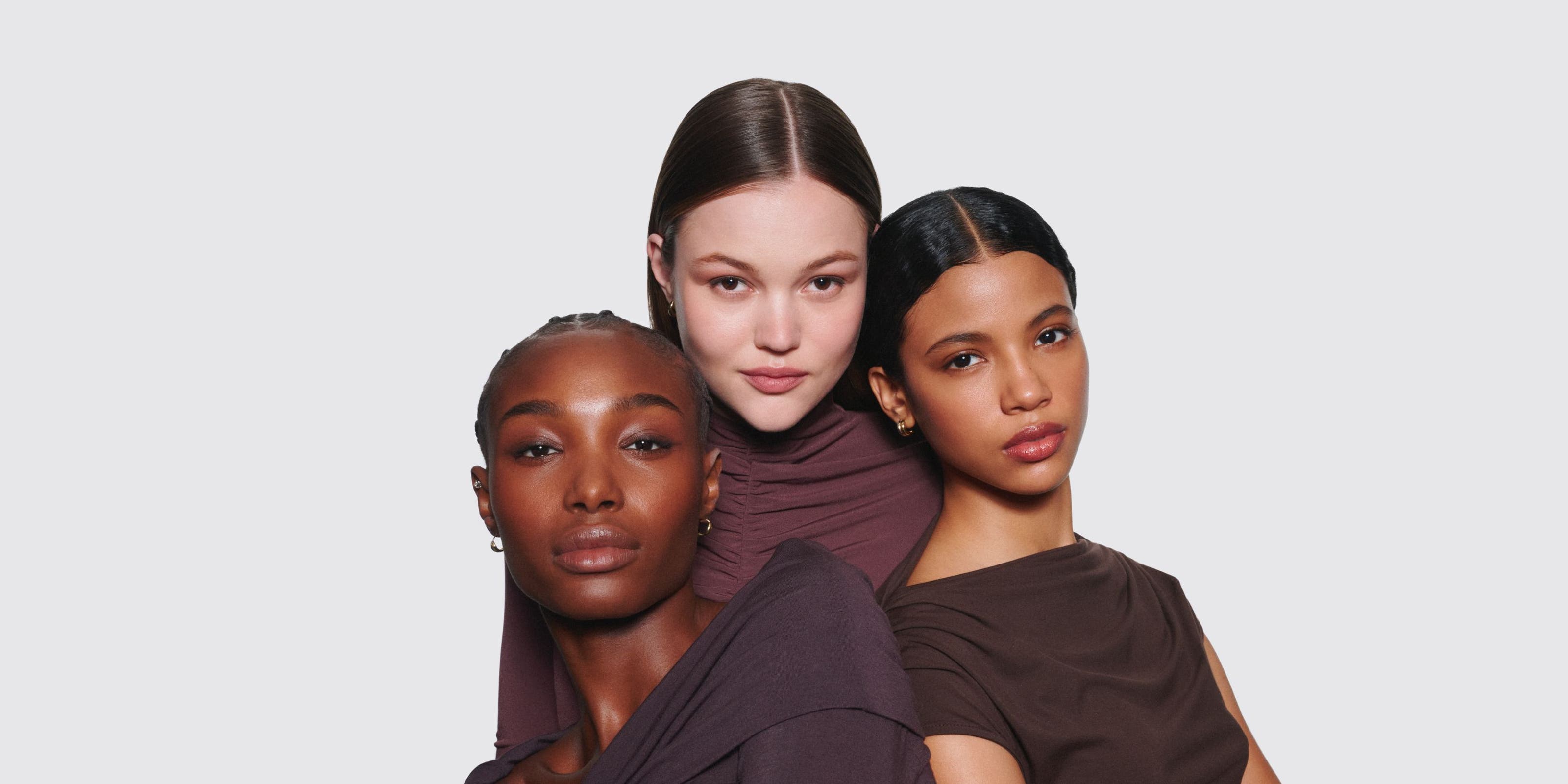 Three women wearing makeup.