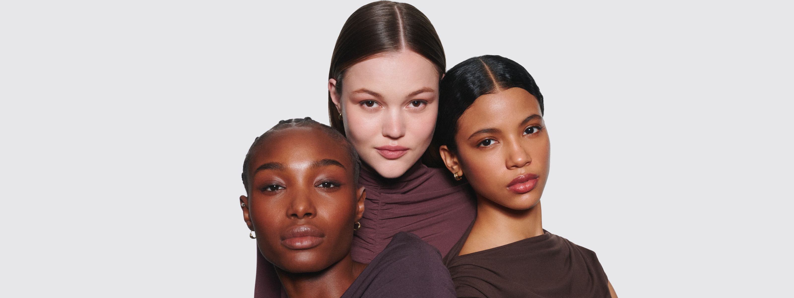 Three women wearing makeup.