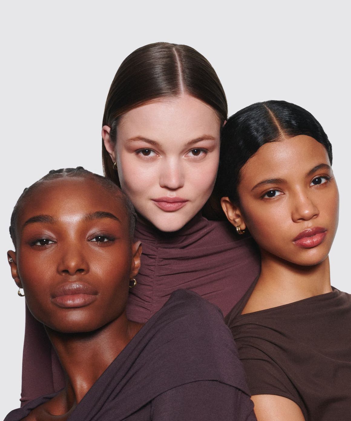 Three women wearing makeup.