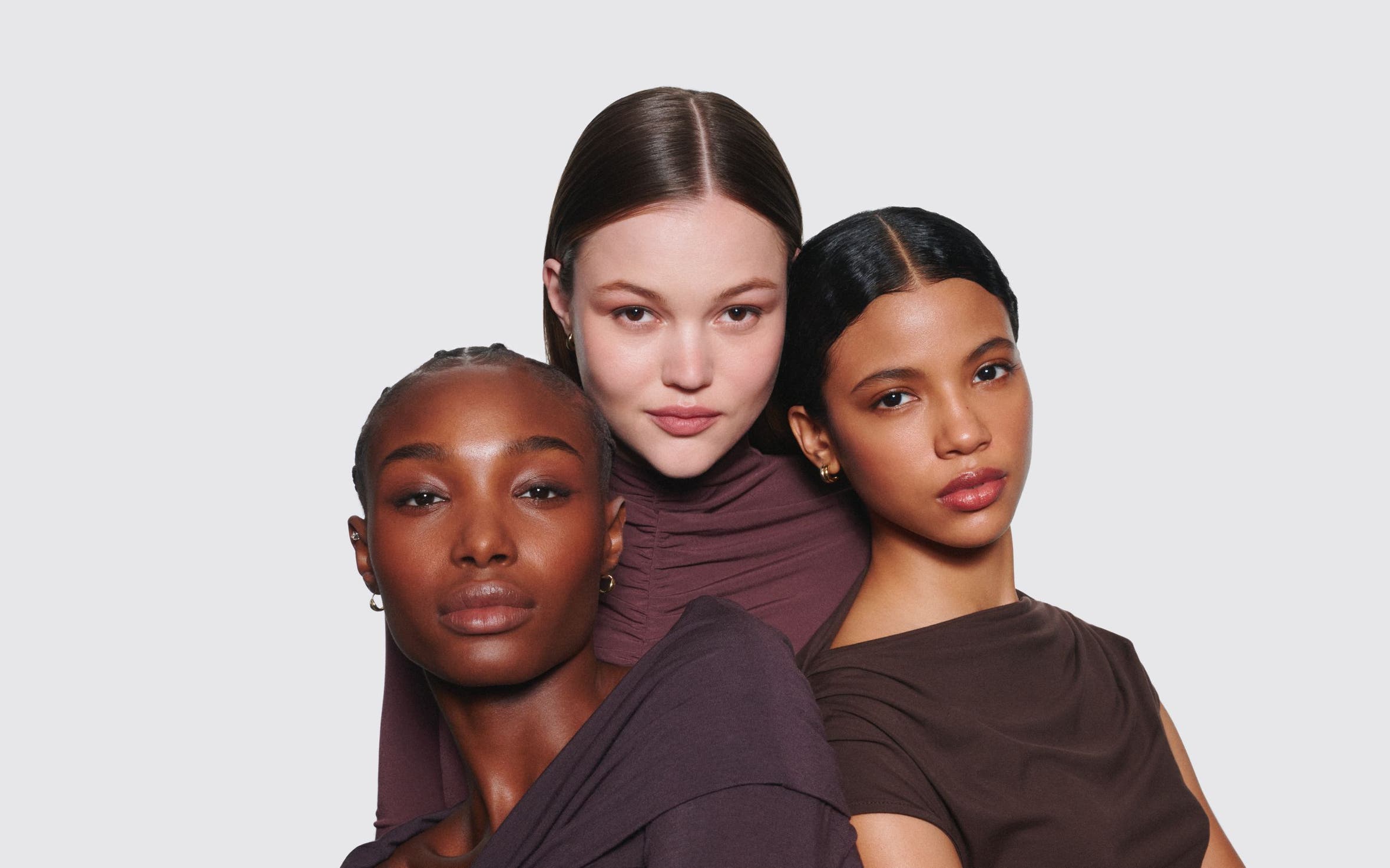 Three women wearing makeup.