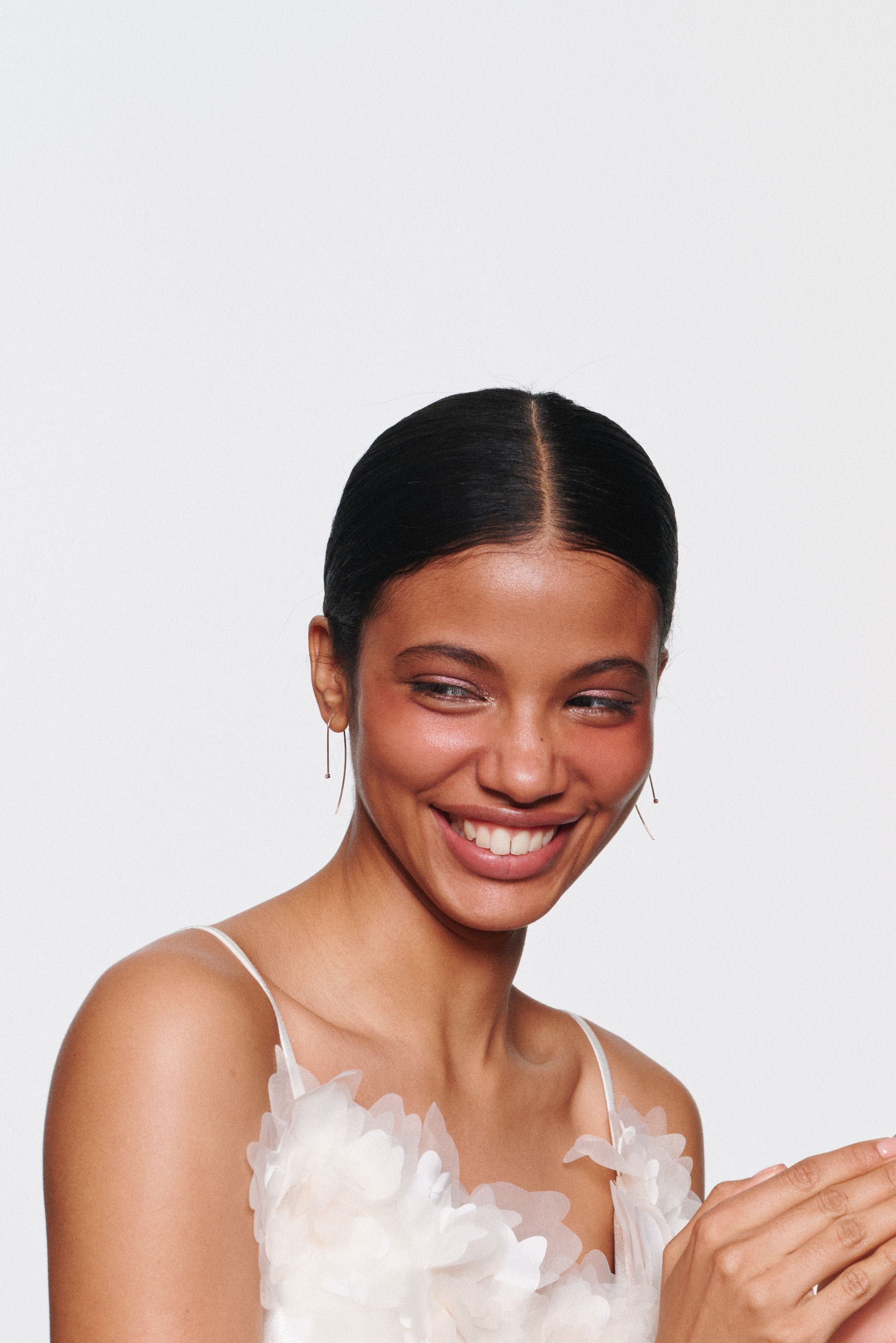 Beauty look with natural glow, soft color and sleek hairstyling.