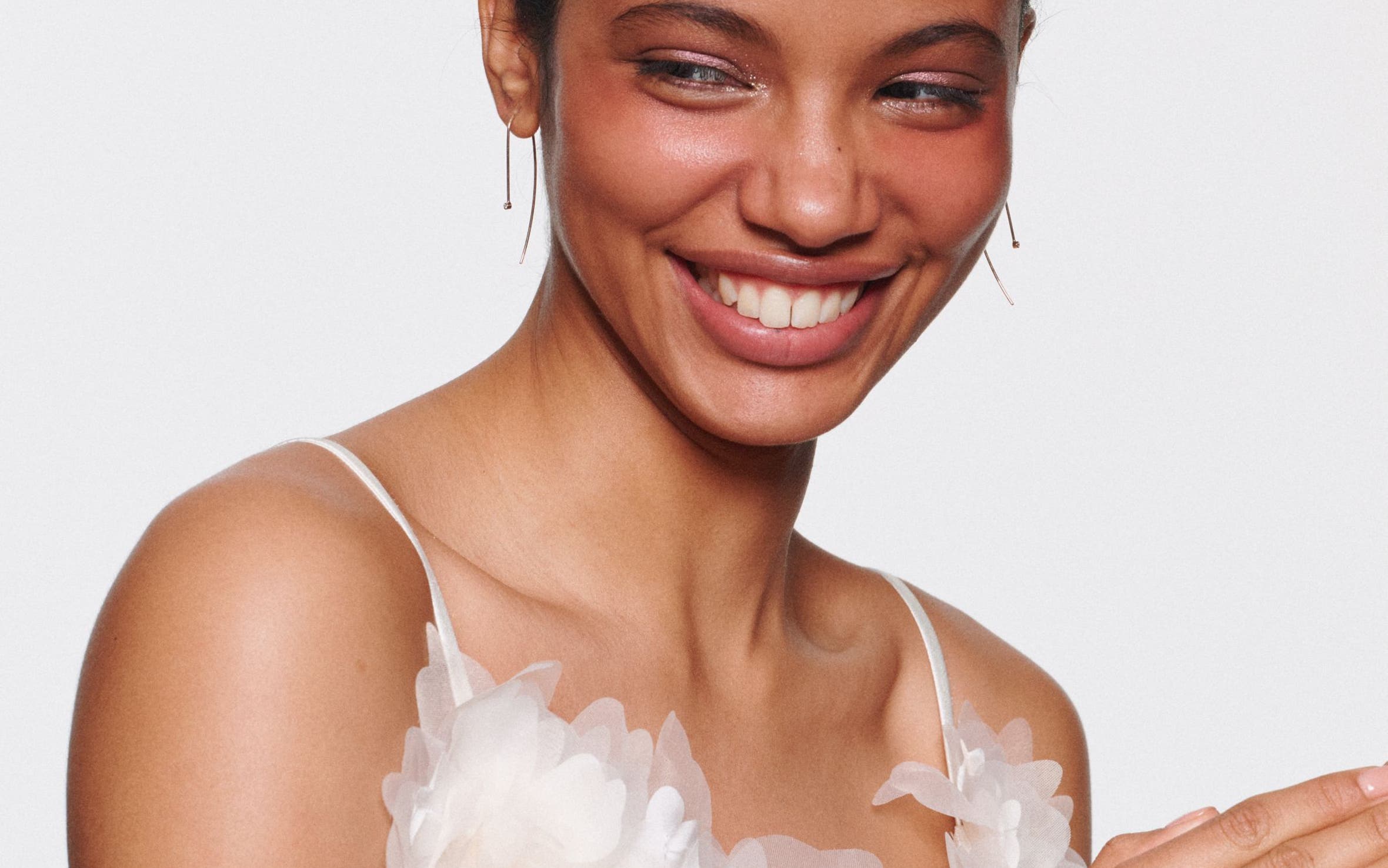 Beauty look with natural glow, soft color and sleek hairstyling.
