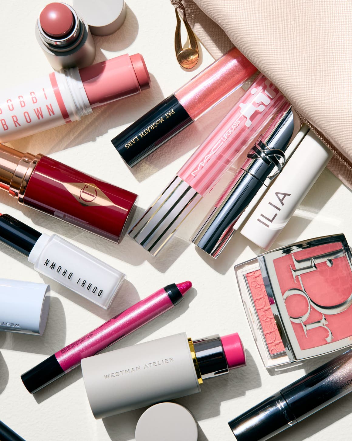 An assortment of makeup products in various shades of pink.