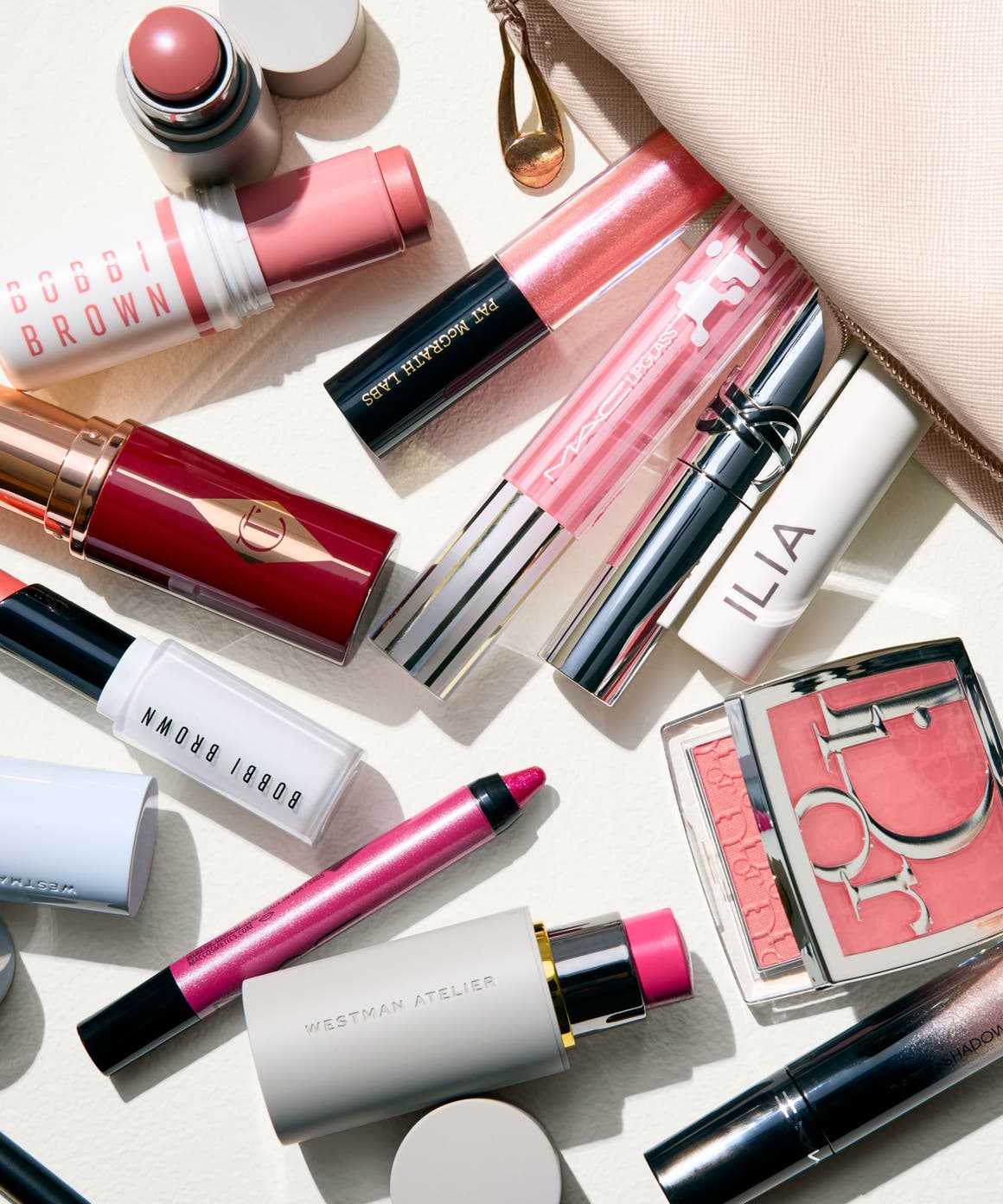 An assortment of makeup products in various shades of pink.