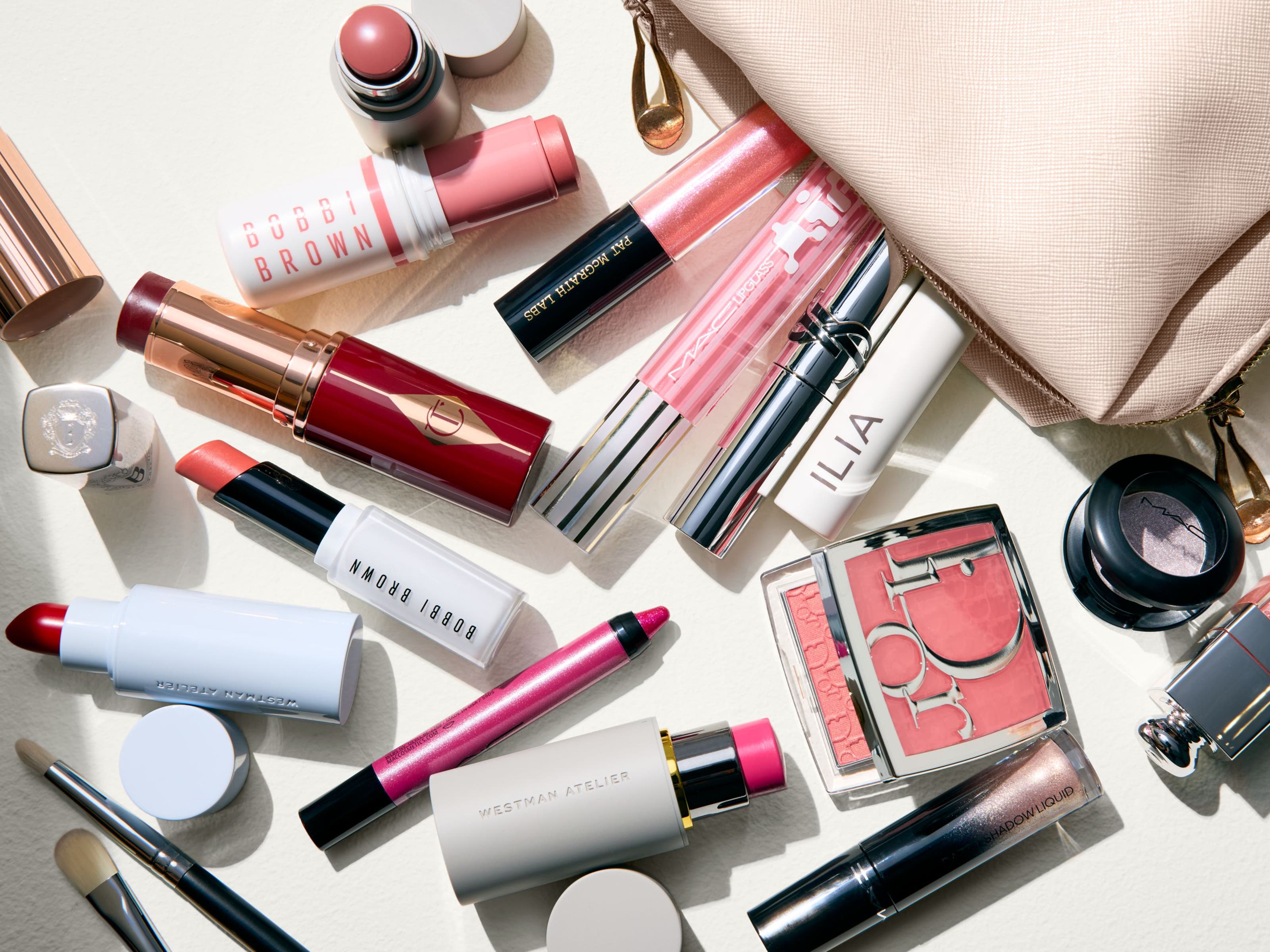 An assortment of makeup products in various shades of pink.