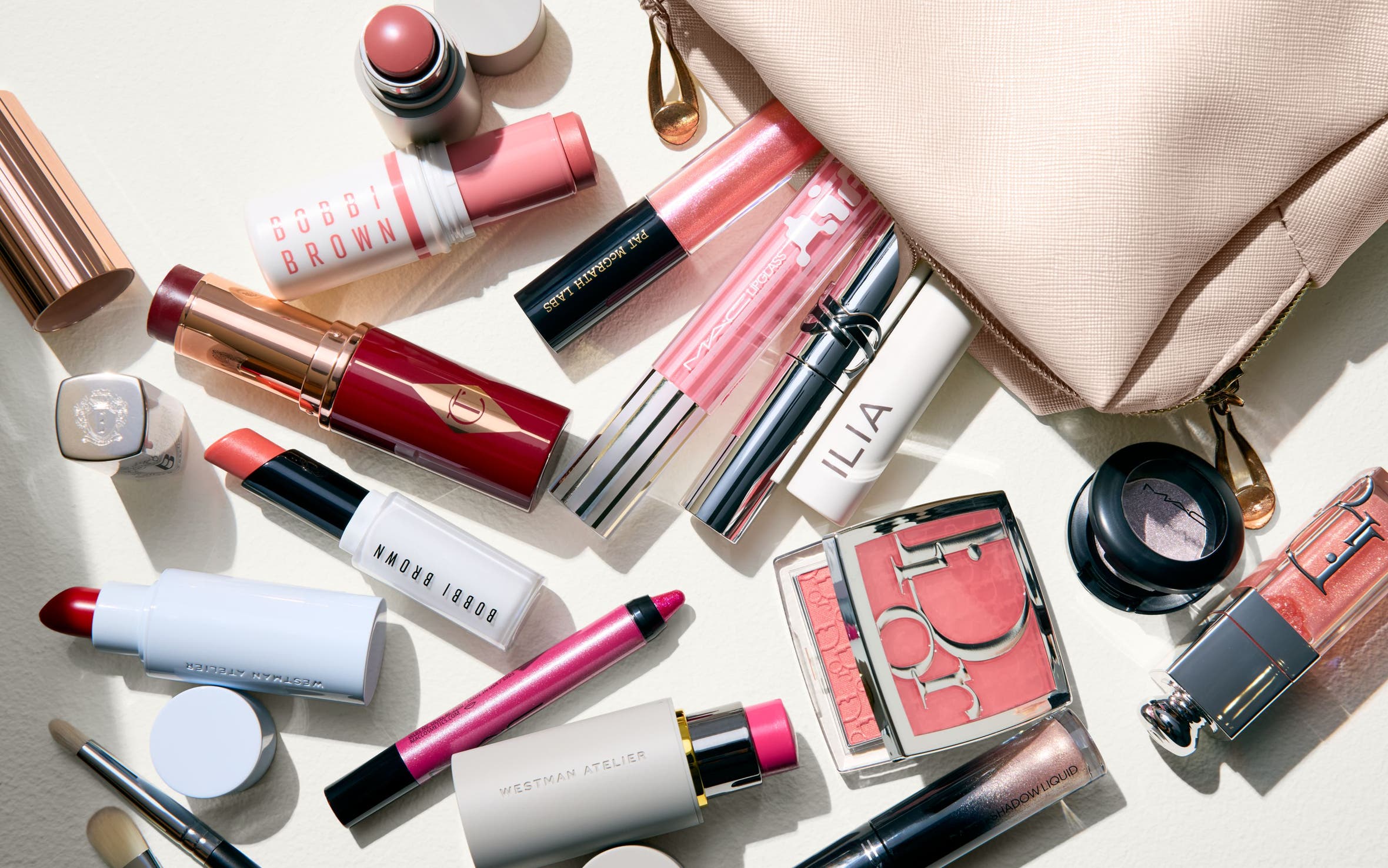 Makeup products spilling out of a bag.