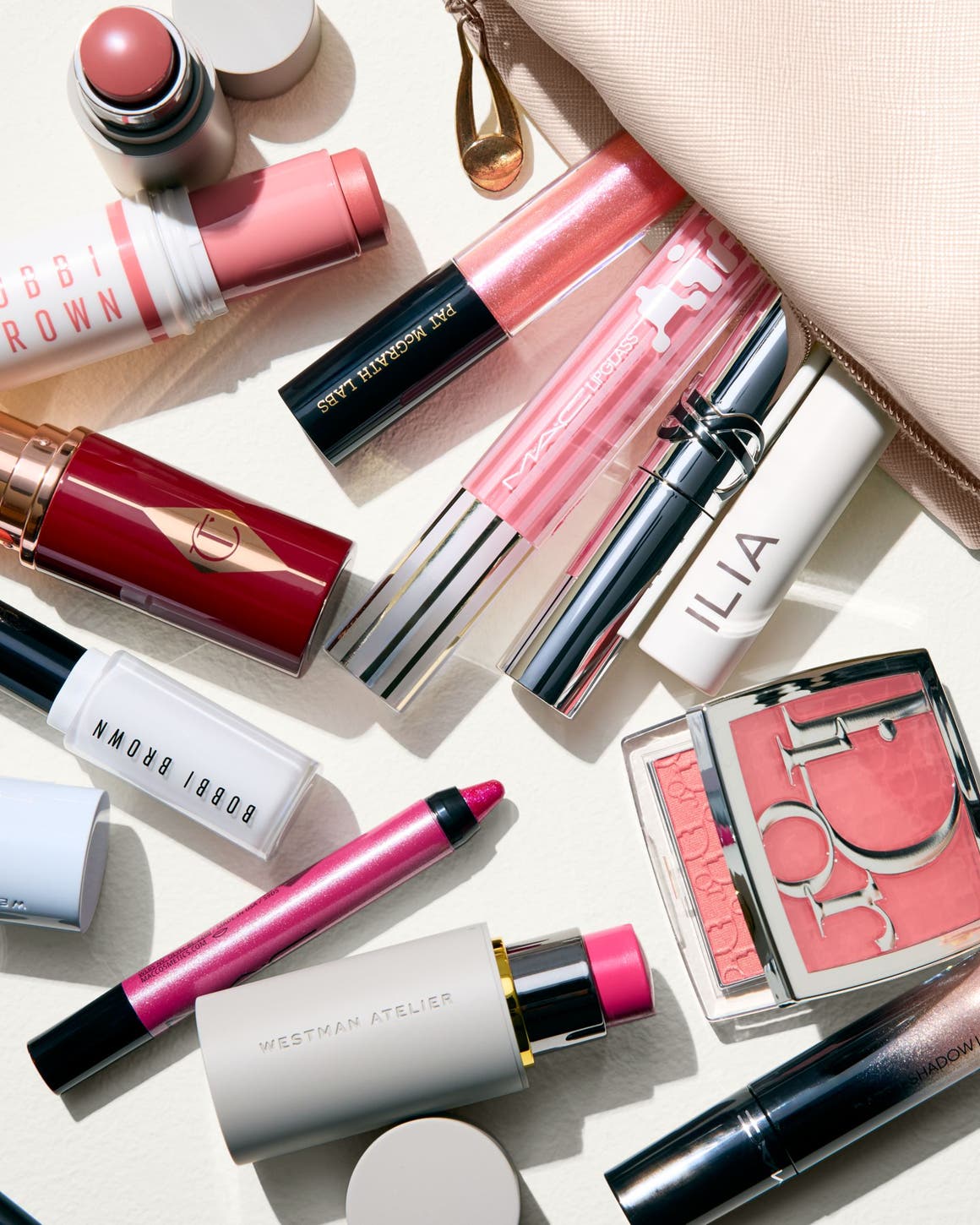 Makeup products spilling out of a bag.