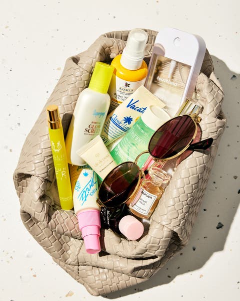 Bag full of Beauty products and sunglasses.