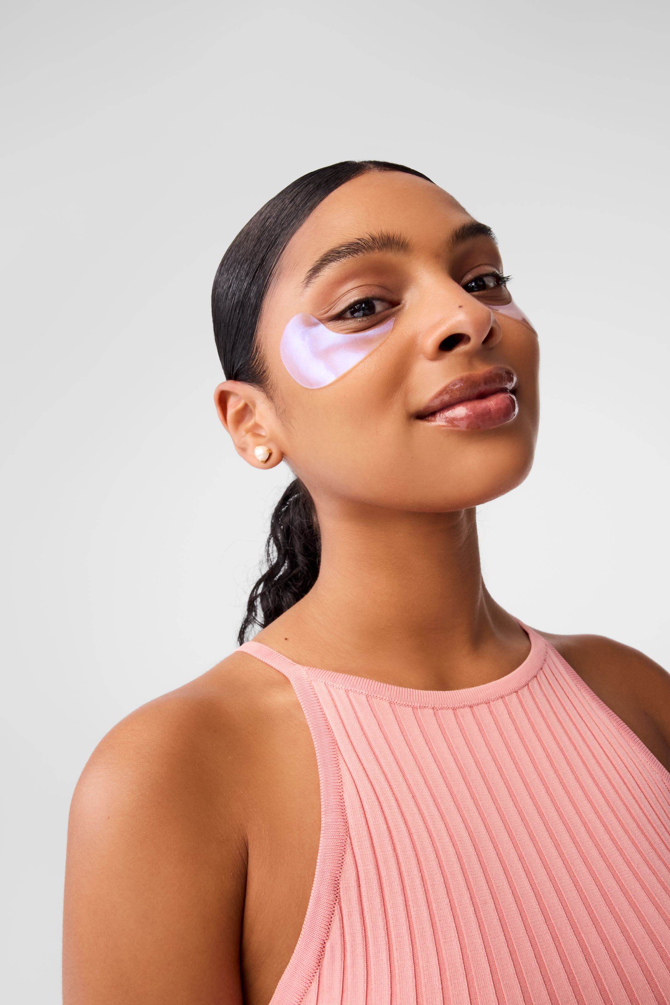 A woman wearing undereye patches.