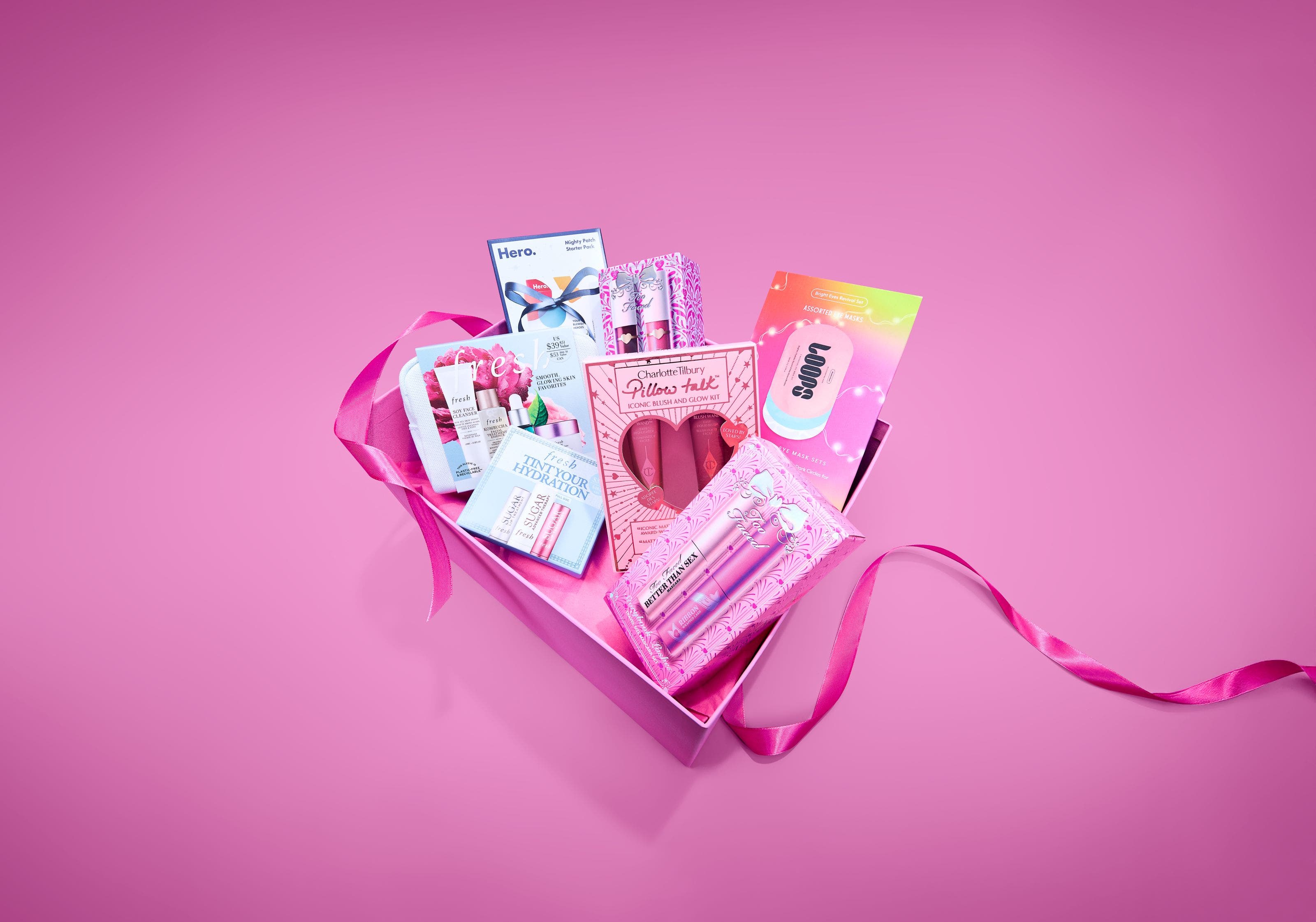 Multiple beauty gift set boxes from Charlotte Tilbury, fresh, Loops, Hero, and Too Faced.