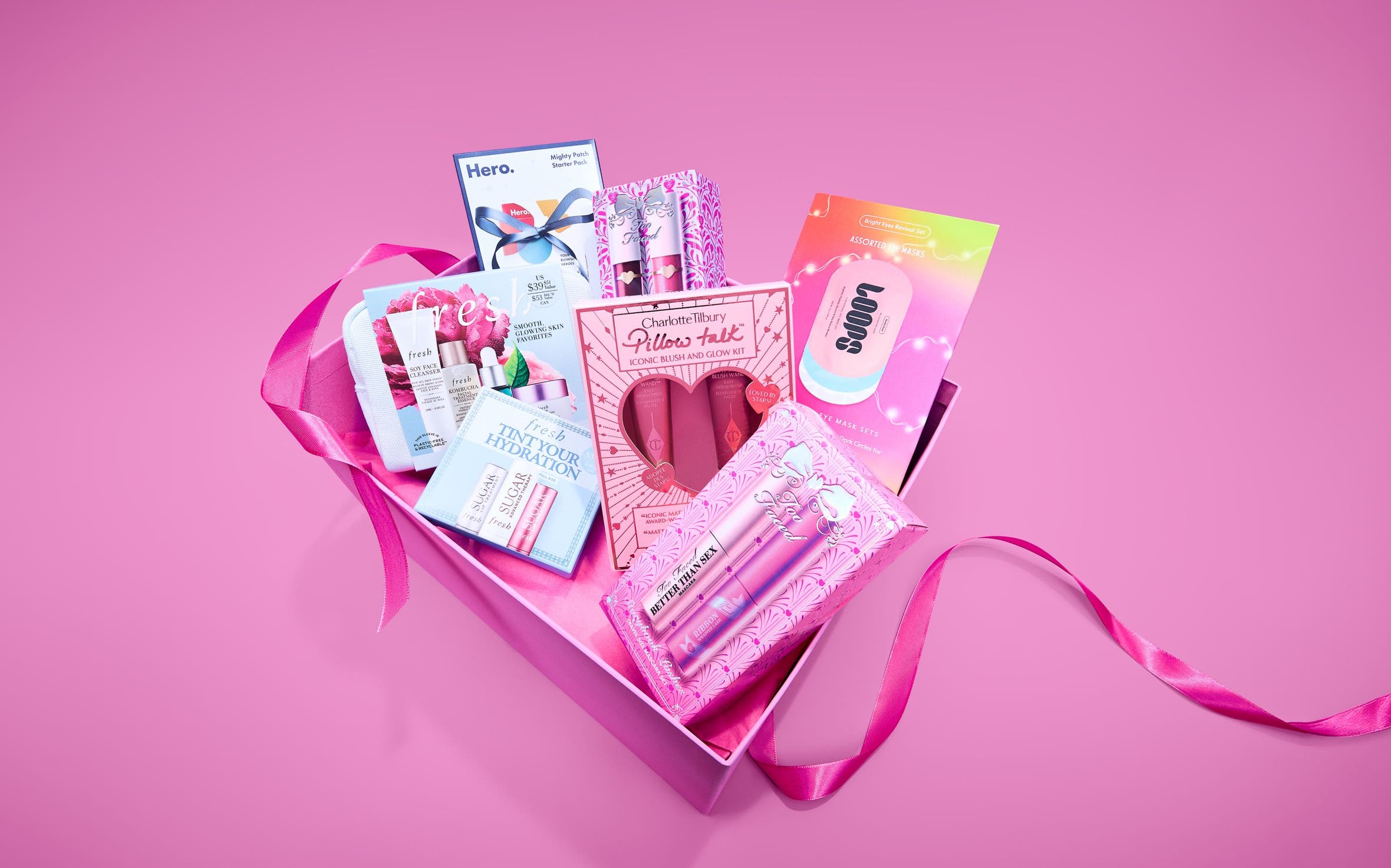 Multiple beauty gift set boxes from Charlotte Tilbury, fresh, Loops, Hero, and Too Faced.