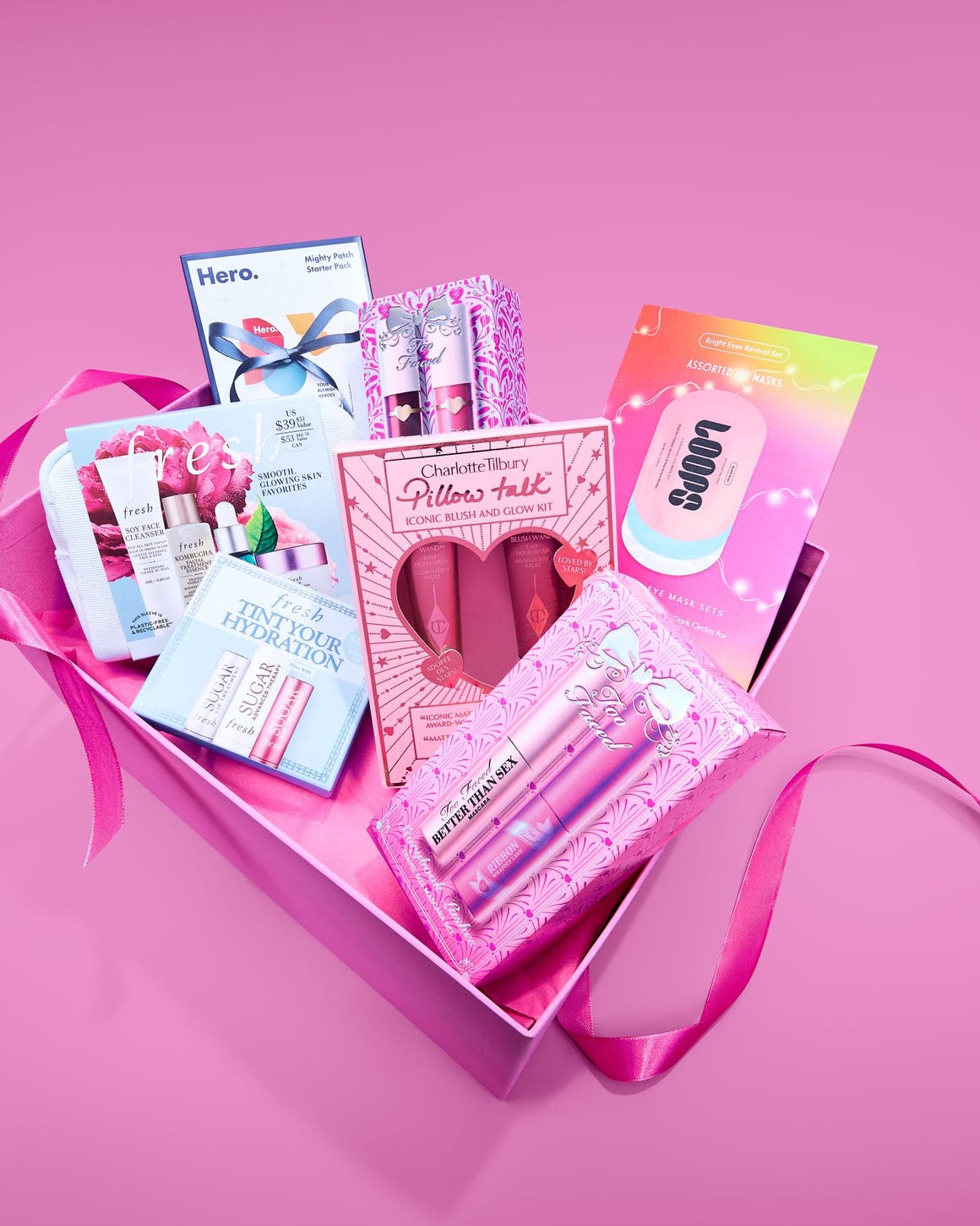 Multiple beauty gift set boxes from Charlotte Tilbury, fresh, Loops, Hero, and Too Faced.