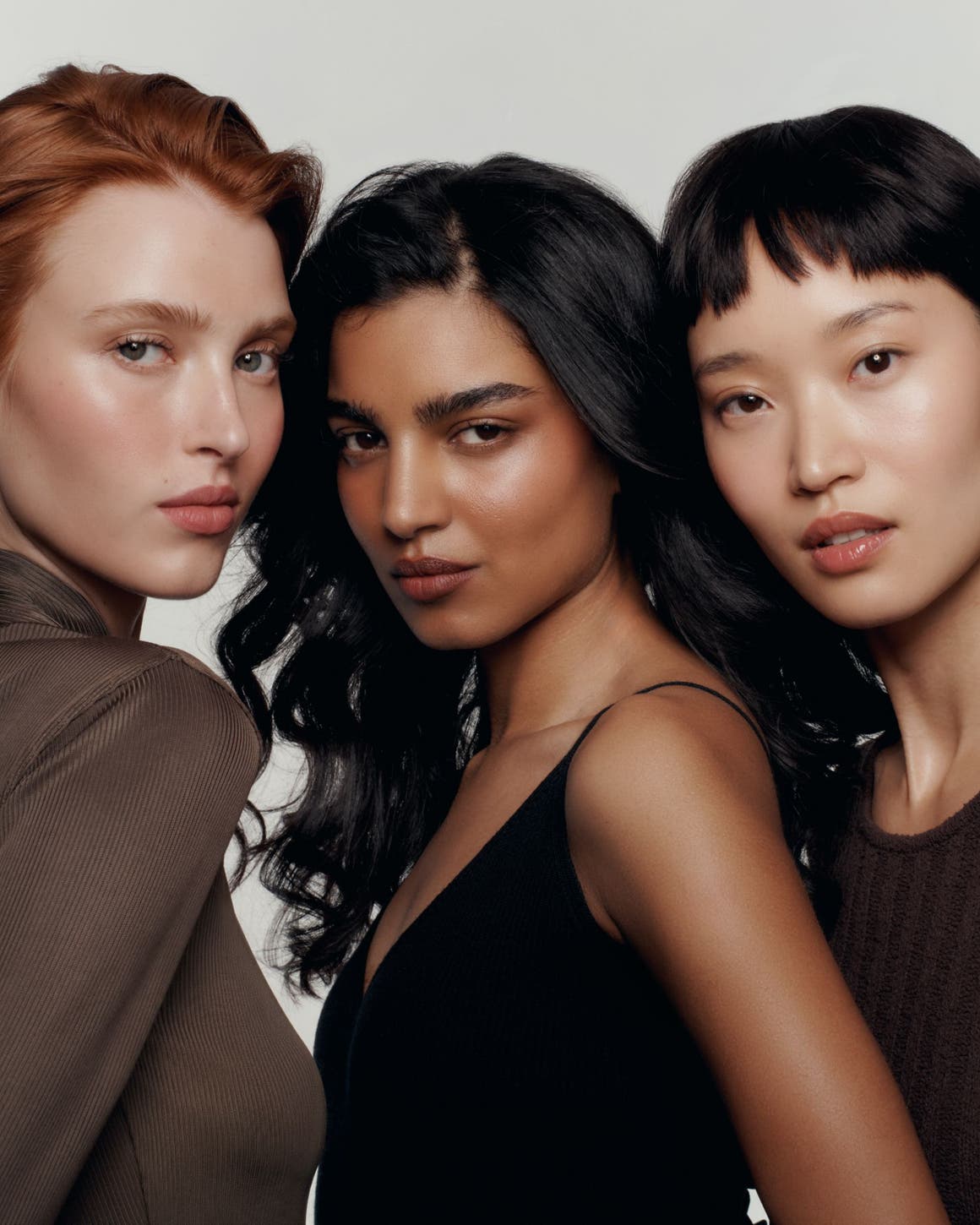 Three models wearing makeup.
