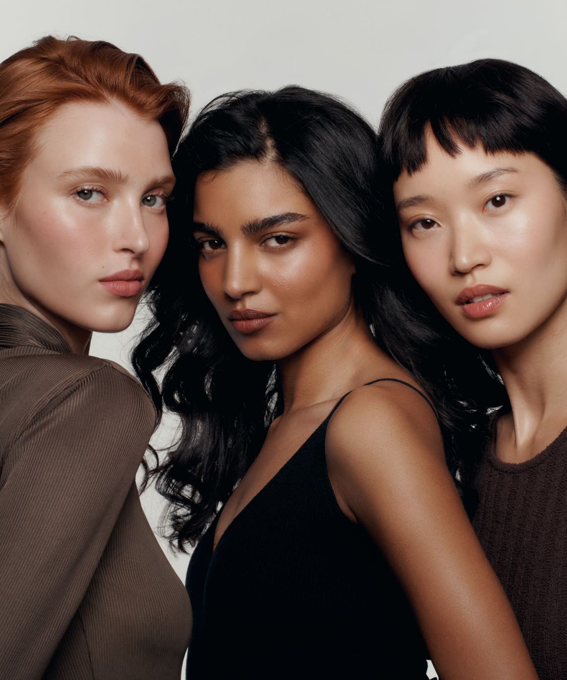 Three models wearing makeup.