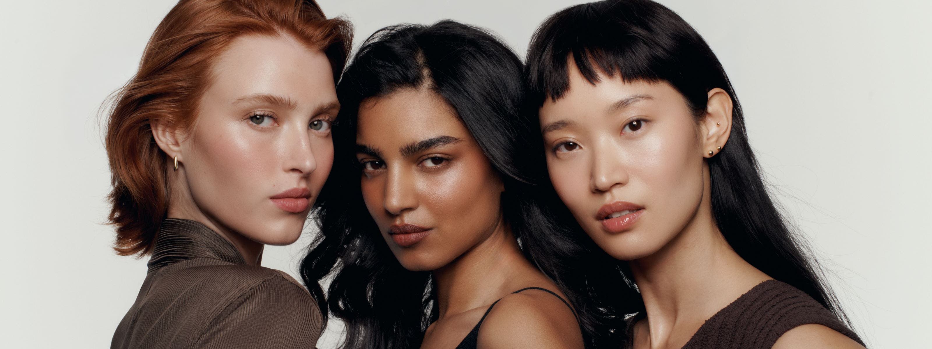 Three models wearing makeup.