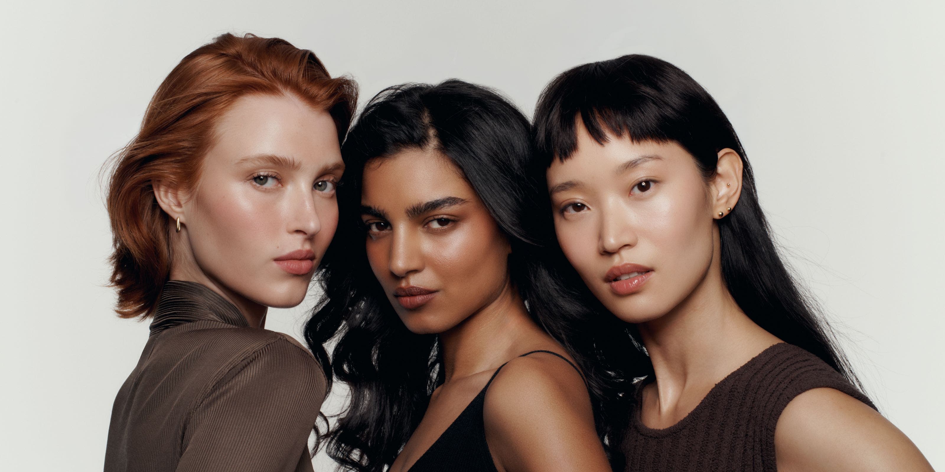Three models wearing makeup.