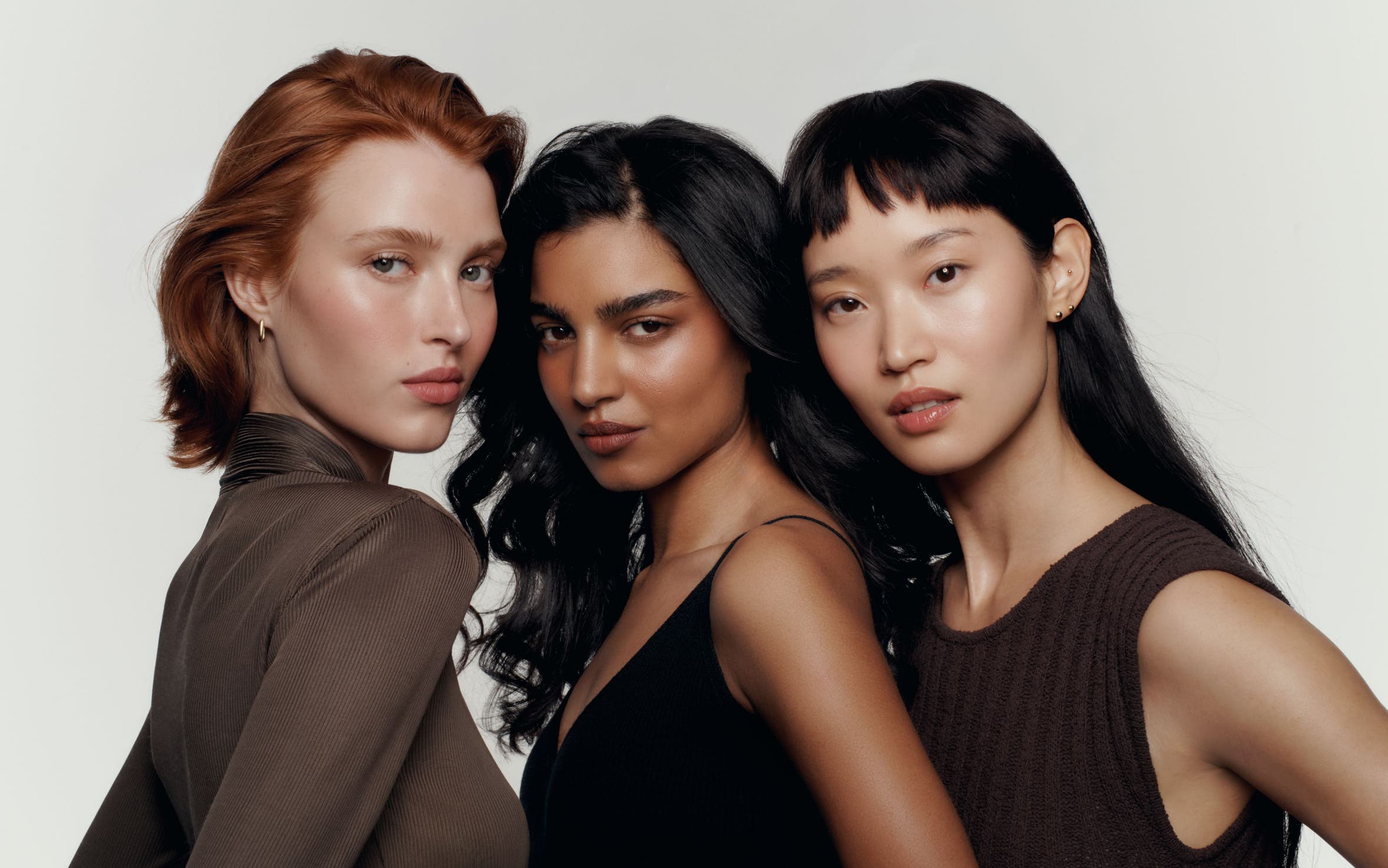 Three models wearing makeup.