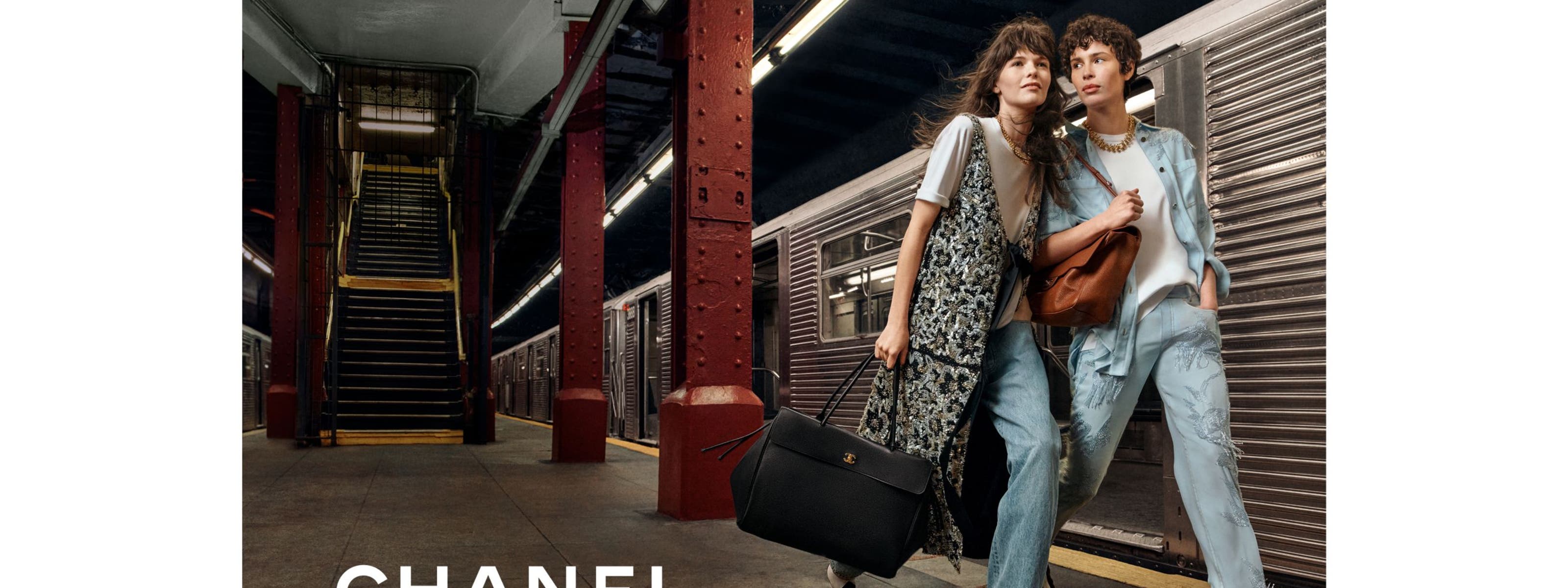 two women at train station wearing CHANEL
