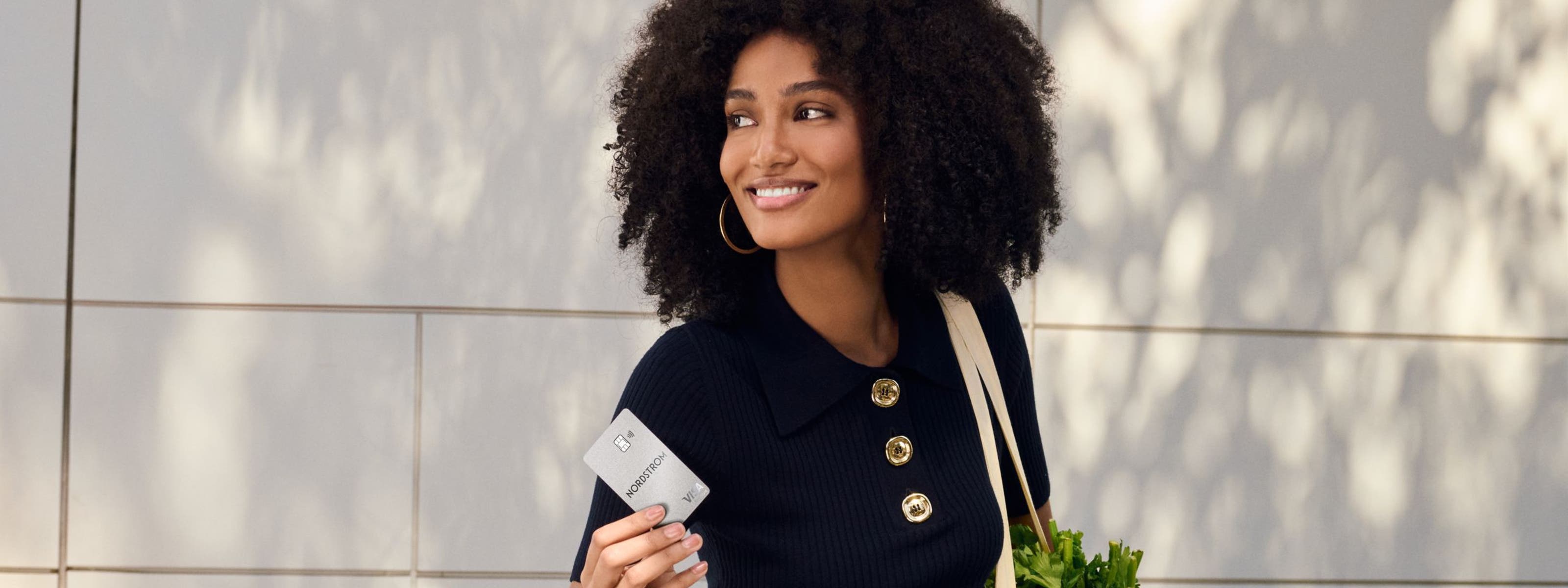 Smiling woman with Nordstrom Visa card.