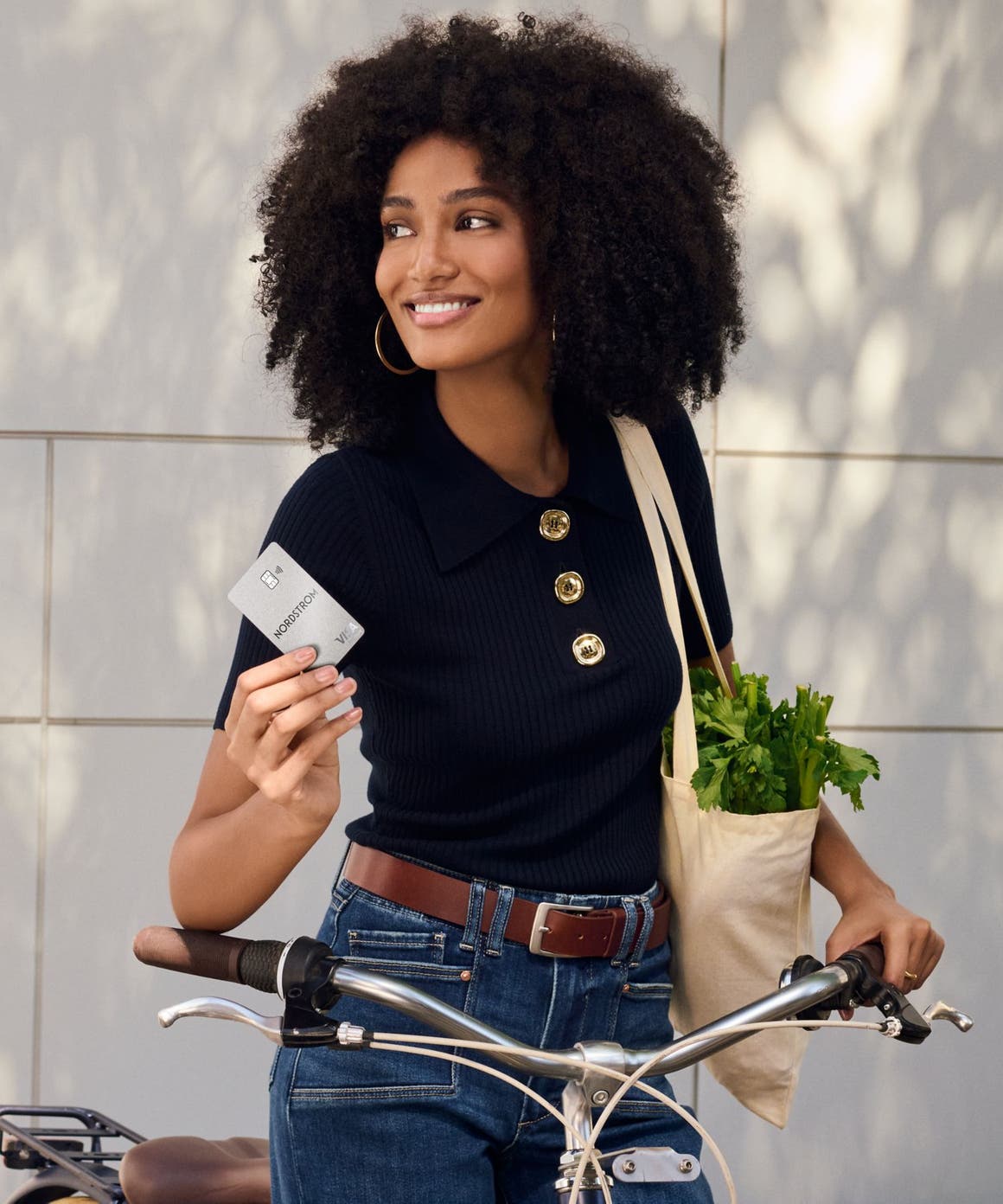 Smiling woman with Nordstrom Visa card.