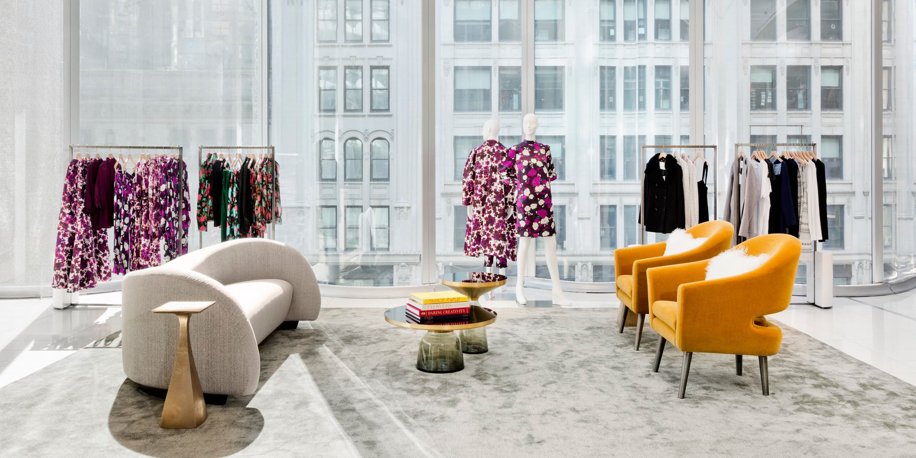A Nordstrom showroom with clothing and lounge chairs.