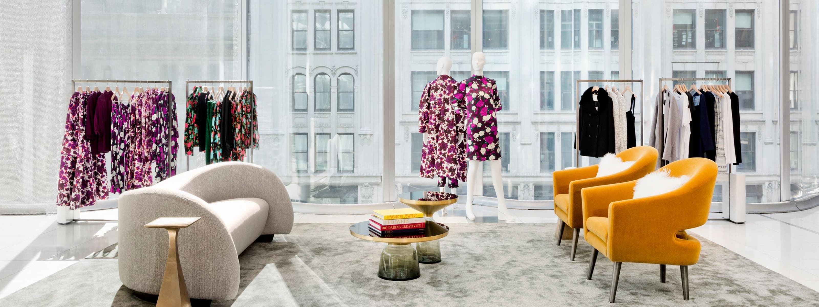 A Nordstrom showroom with clothing and lounge chairs.