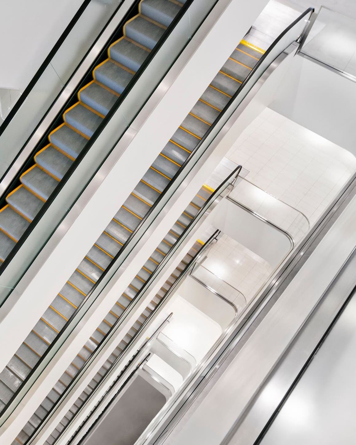 A view of multiple escalators in a Nordstrom store.