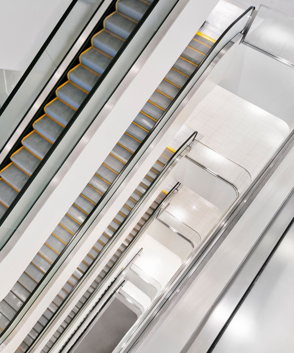 A view of multiple escalators in a Nordstrom store.